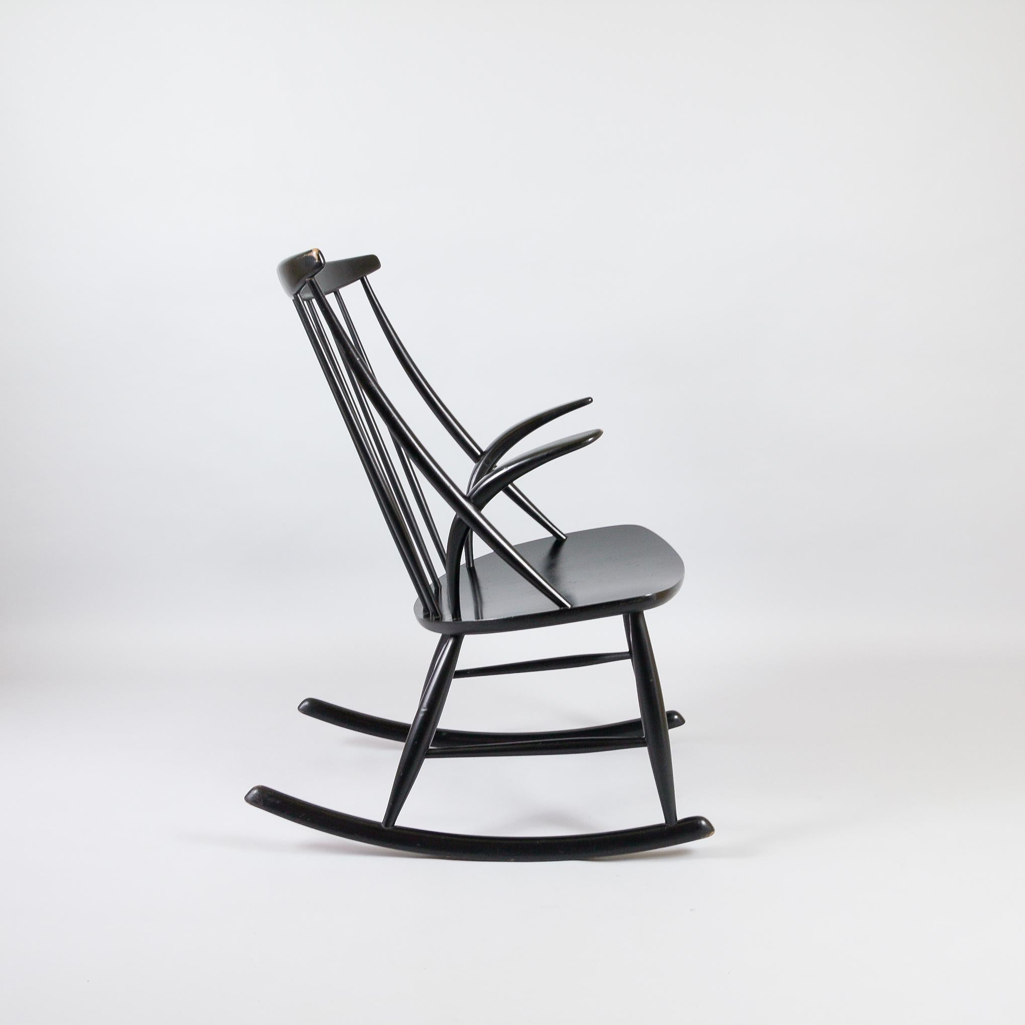 Black lacquered Illum Wikkelsø Gyngestol No.3 rocking chair manufactured by Niels Eilerson. Designed 1958. Spindle back with distinctive short, curved arms. This rocker is in great vintage condition with wear commensurate with age.