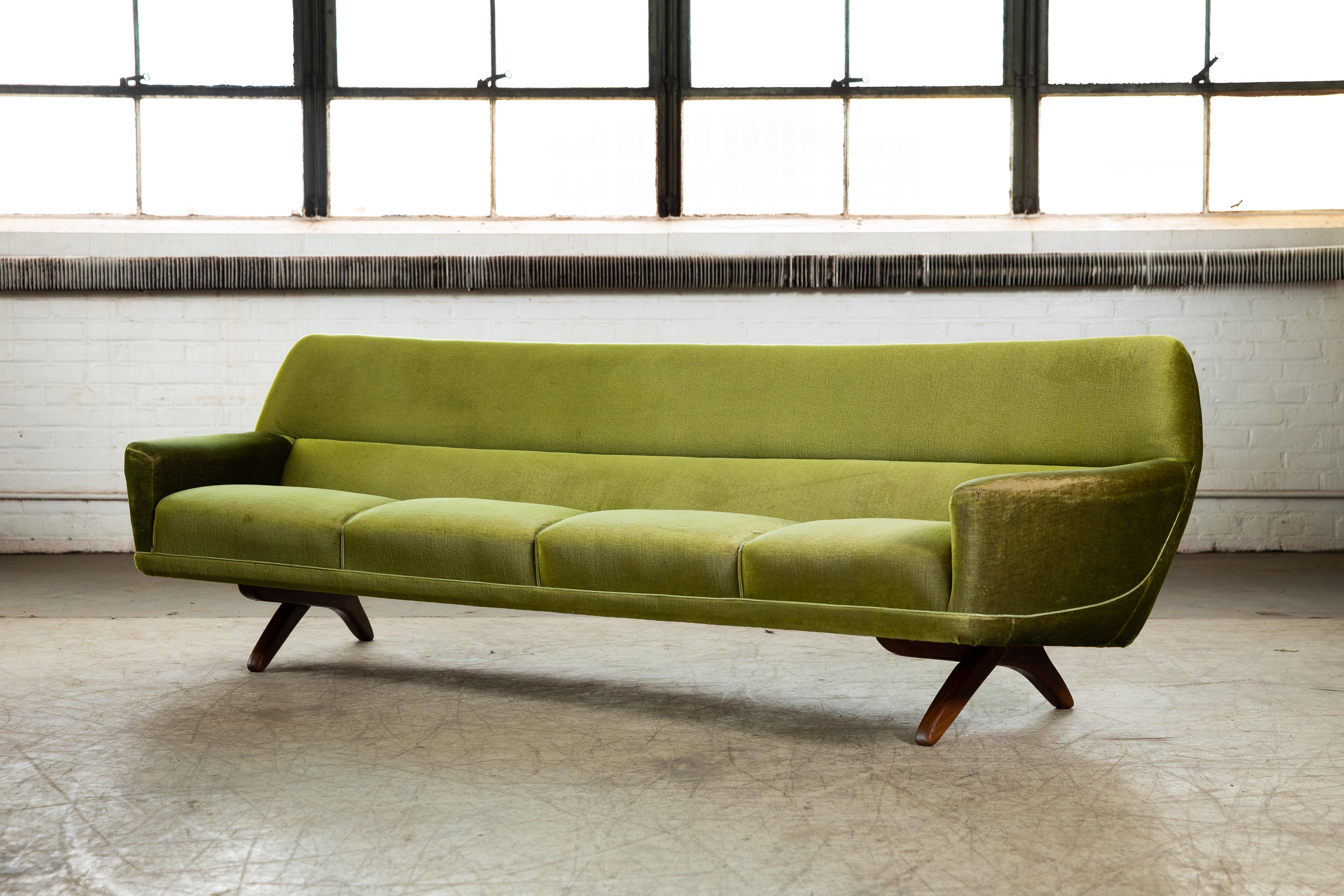 Stunning large Danish modern 1960s sofa designed by Illum Wikkelso and manufactured by Soren Willadsen in the early 1960s. Cross leg design in solid teak typical for many of Wikkelso's iconic designs and beautiful rounded organic lines. Wikkelso has