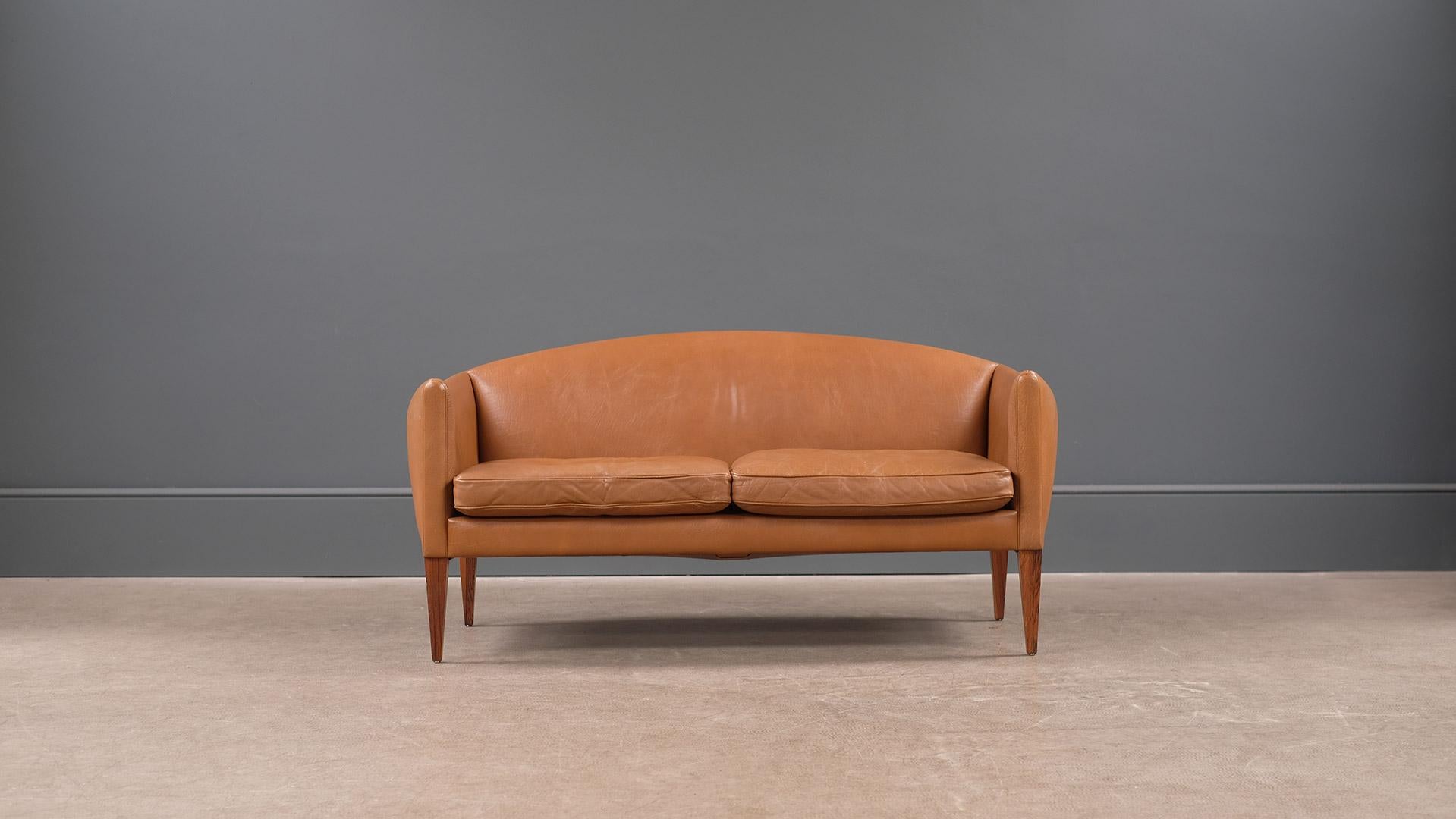 Wonderful super rare small sofa / loveseat designed by Illum Wikkelso for cabinetmaker Holger Christiansen, Denmark. Beautiful proportions, super elegant and very comfortable.