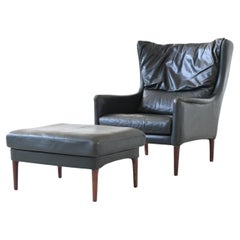 Illum Wikkelso lounge chair and foot stool in leather Denmark 1960