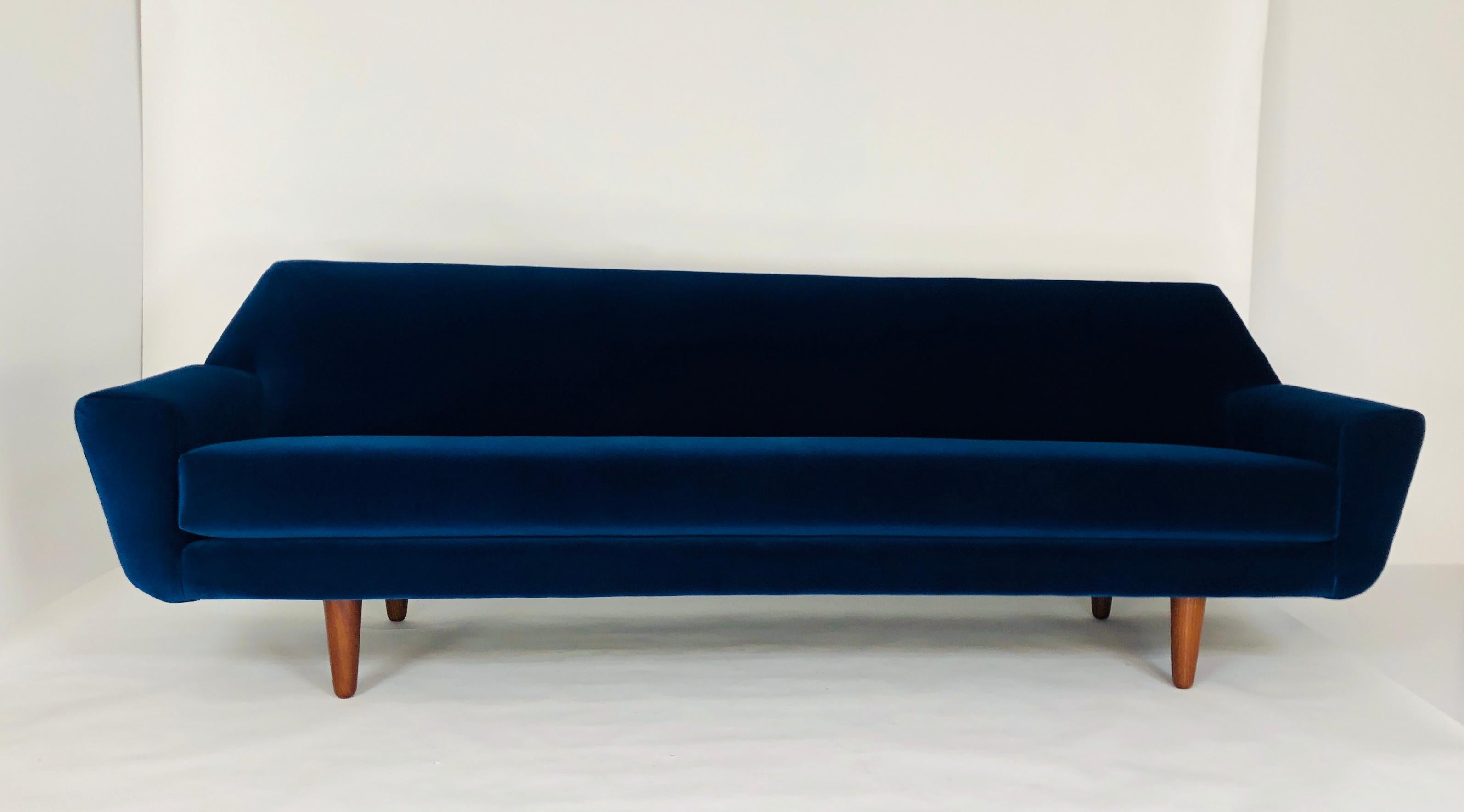 Very sleek Danish midcentury sofa. Refurbished and covered with navy blue cotton velvet upholstery. Four rosewood conic legs.