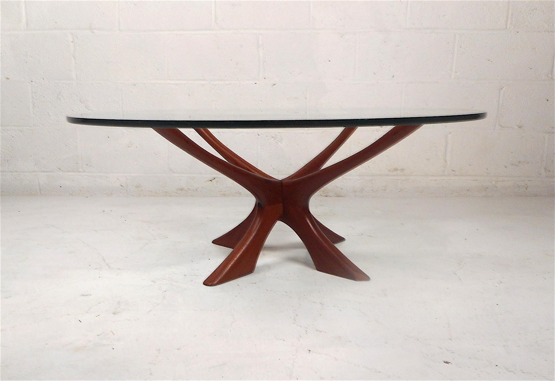 Stylish Danish modern glass top table with a sculptural teak base. Designed by Illum Wikkelso, circa 1950s. Glass top is 1/2 and inch thick. Great piece sure to make an impression in any modern interior. Please confirm item location with dealer (NJ