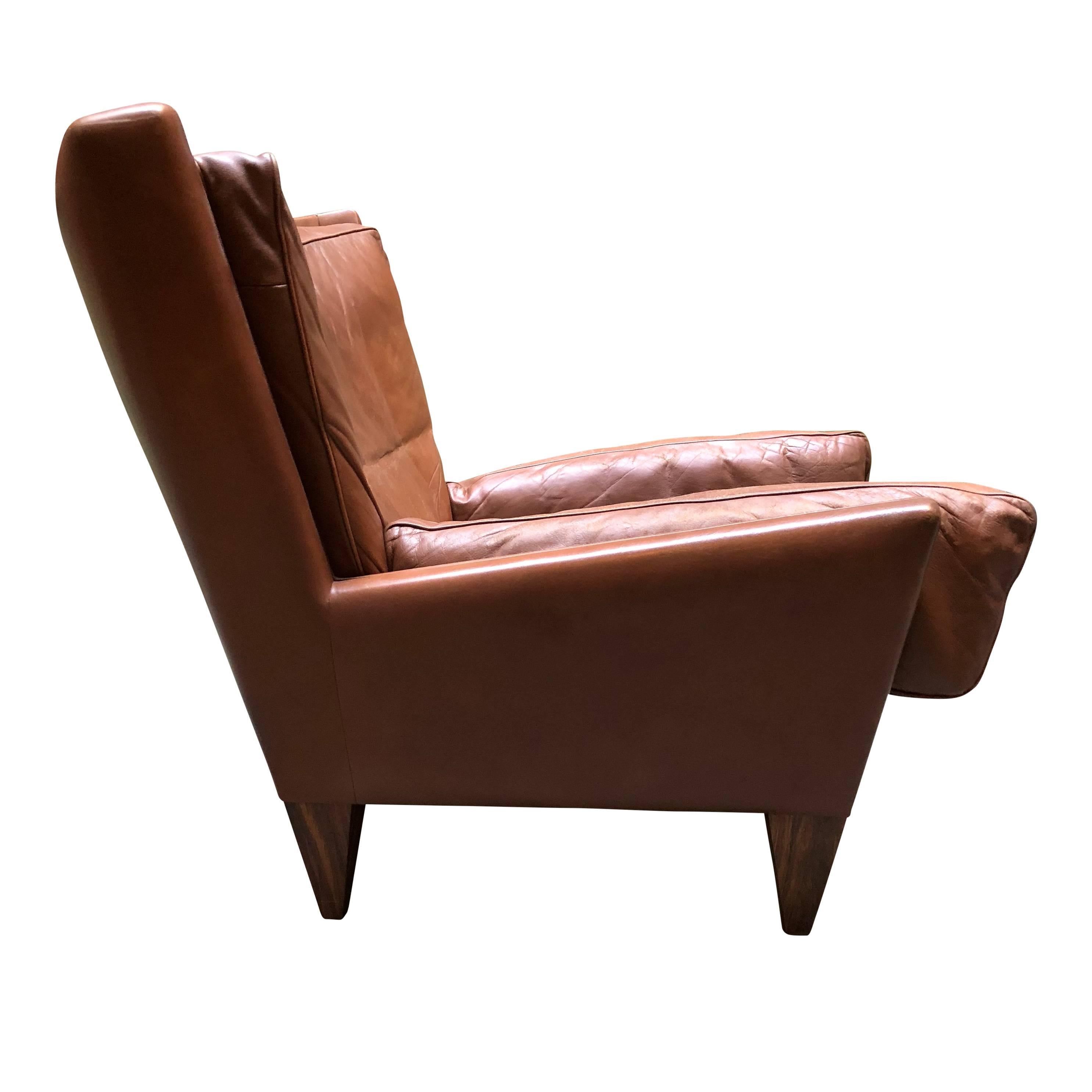 For your consideration is a rare Illum Wikkelso V11 pyramid lounge chair in supple brown leather for Holger Christiansen. 

This rare char is a cozy addition to any abode. The down-filled cushions allow you to gracefully relax.

Slight wear to