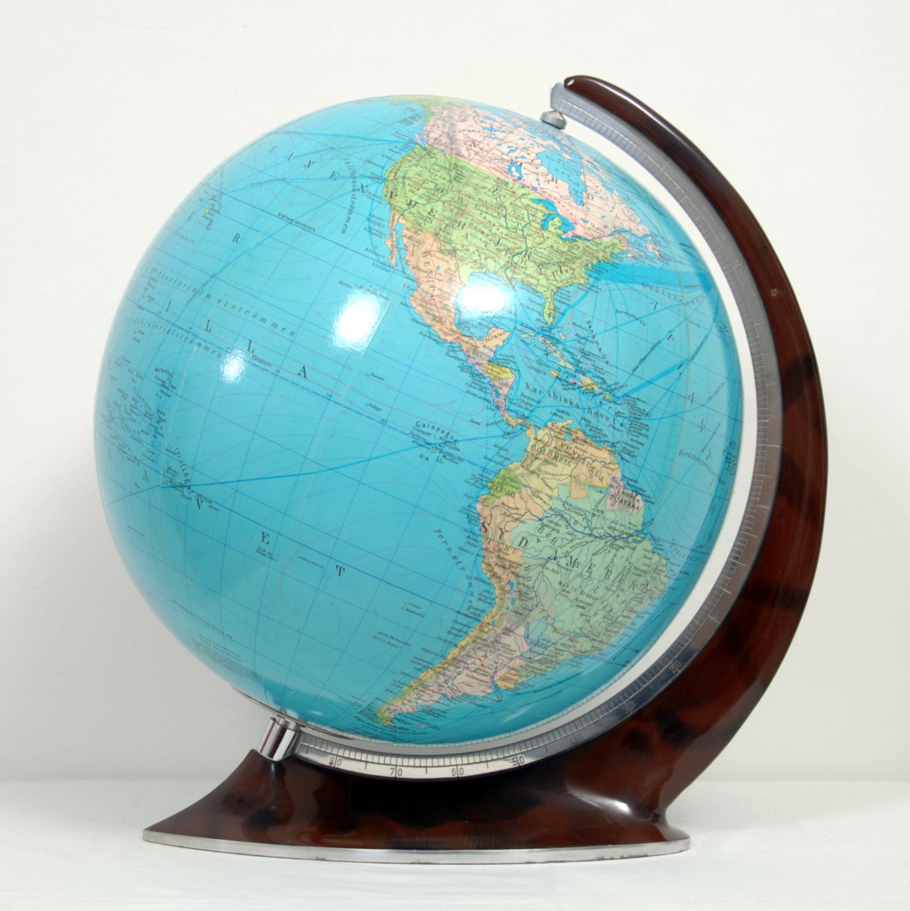 Glass sphere with a brown bakelite and steel frame in Art Deco style by Columbus, Germany. With references in Swedish. The Columbus Verlag Paul Oestergaard is the world's oldest globe manufacturer and is still producing quality globes today.
 