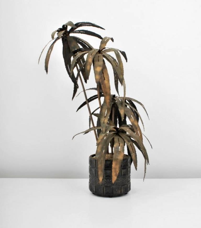 A spectacular illuminated torch-cut palm tree sculpture in a Brutalist Paul Evans style pot, circa 1970. We are unsure the maker but attribute it to Maison Jansen and also shares a similar style as C. Jere for Artisans House, Tom Greene, and Silas