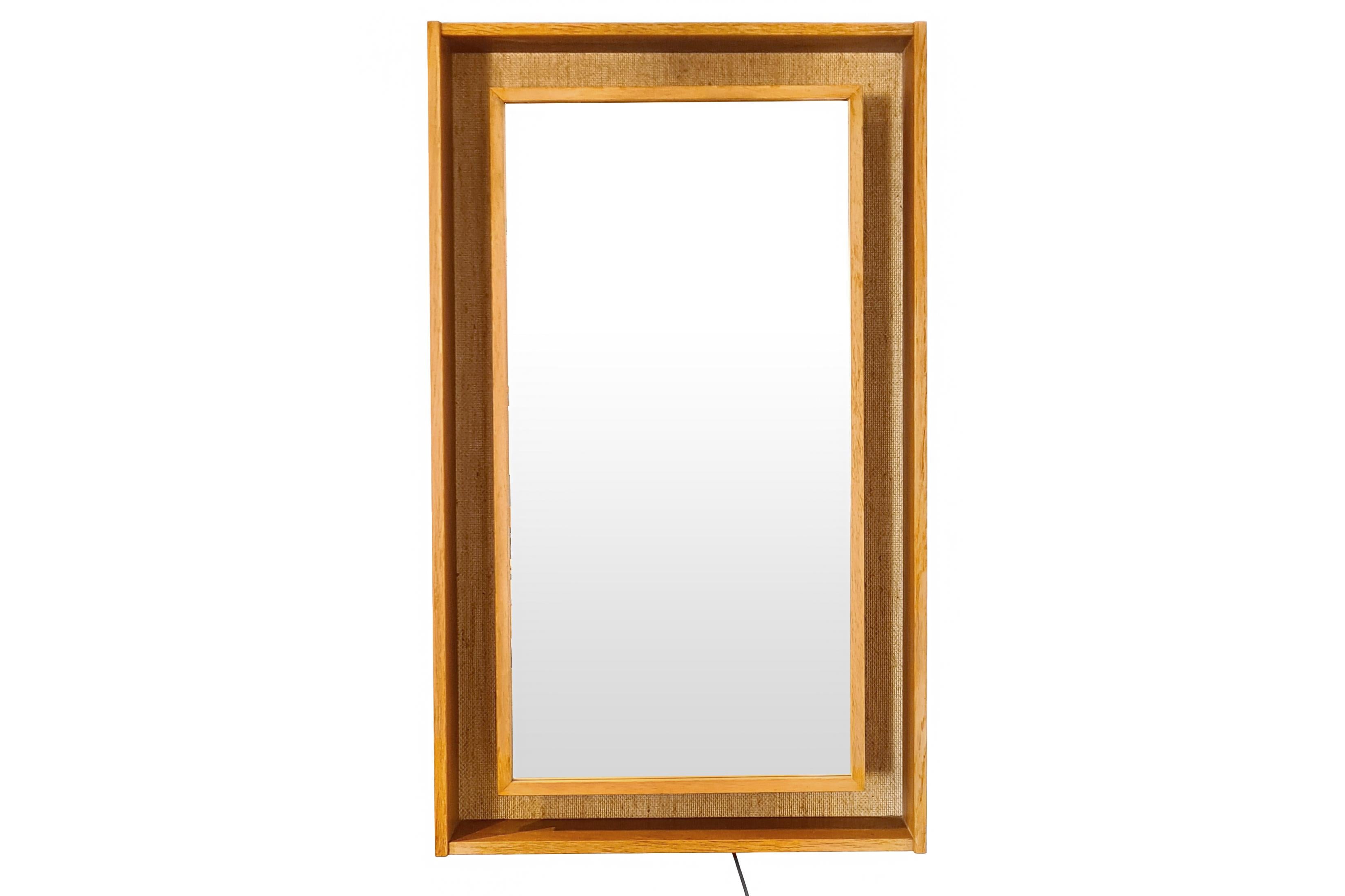 Large impressive rectangular Danish design mirror with rear light designed by Pedersen & Hansen from Viby in Denmark. Pedersen & Hansen are known as the high-end designers of beautifully crafted design mirrors. Behind the mirror is a jute-covered