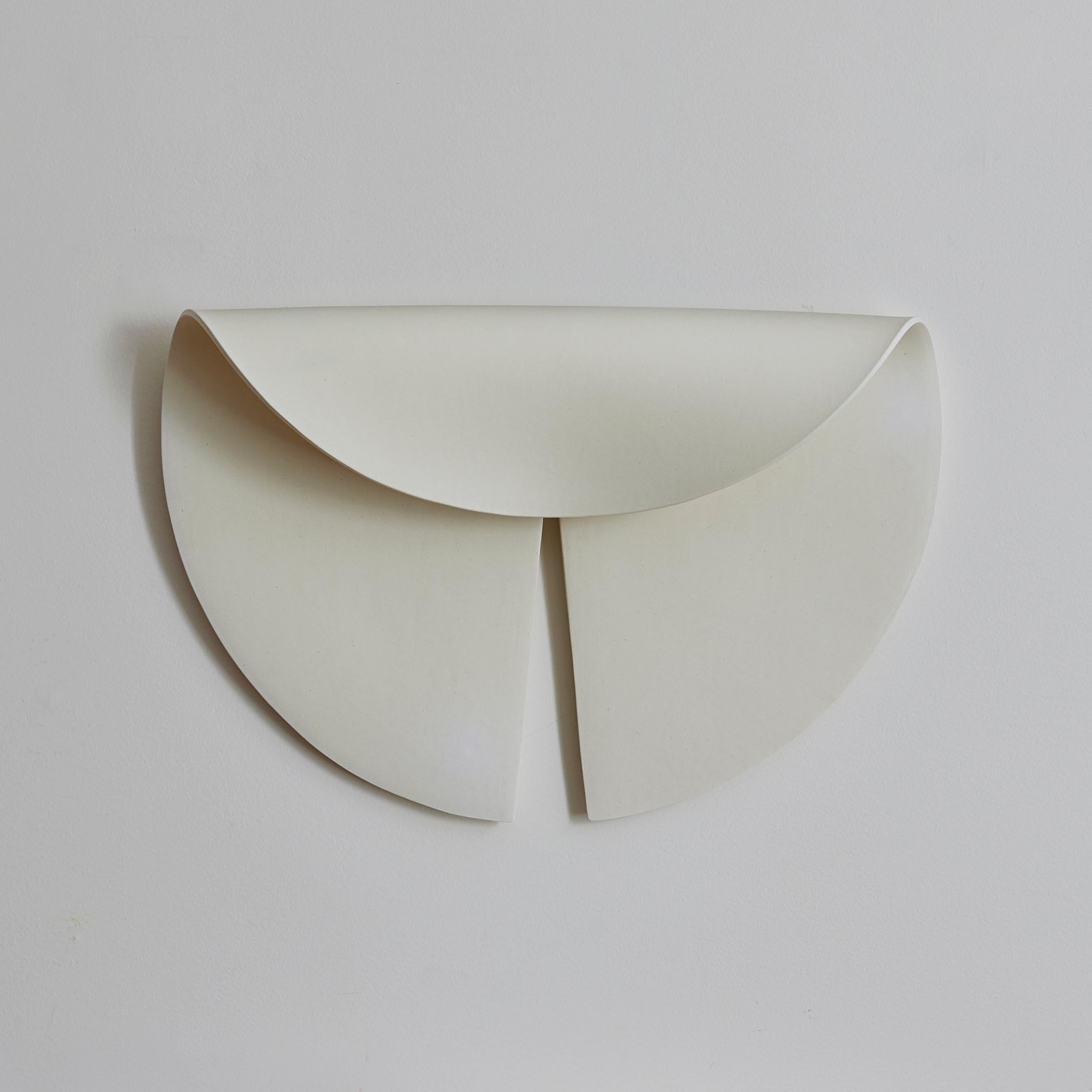 Illuminated Leaf is a ceramic wall sculpture and sconce made by Olivia Barry by Hand. The folded shape of the white earthenware shape hides the light source while allowing the ambient light to project onto the piece. 

Hardwired for US 120 V.