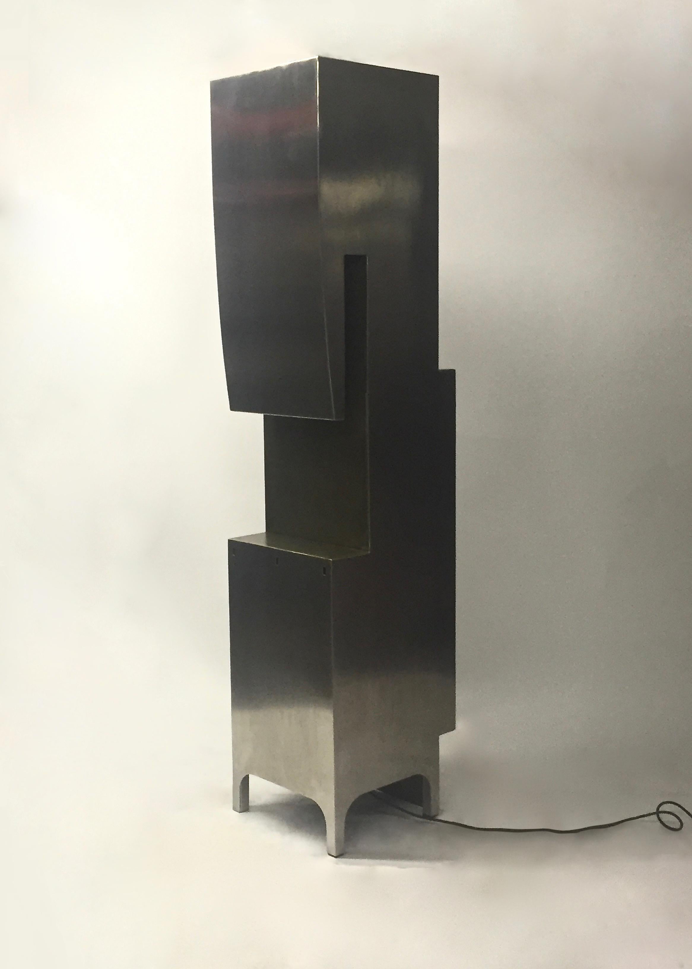 Stainless steel illuminated standing sculpture titled 'Little Buildings' by Jonathan Singleton for SIG Furniture comprises geometric cutouts and two lights with the original signed metal tag.