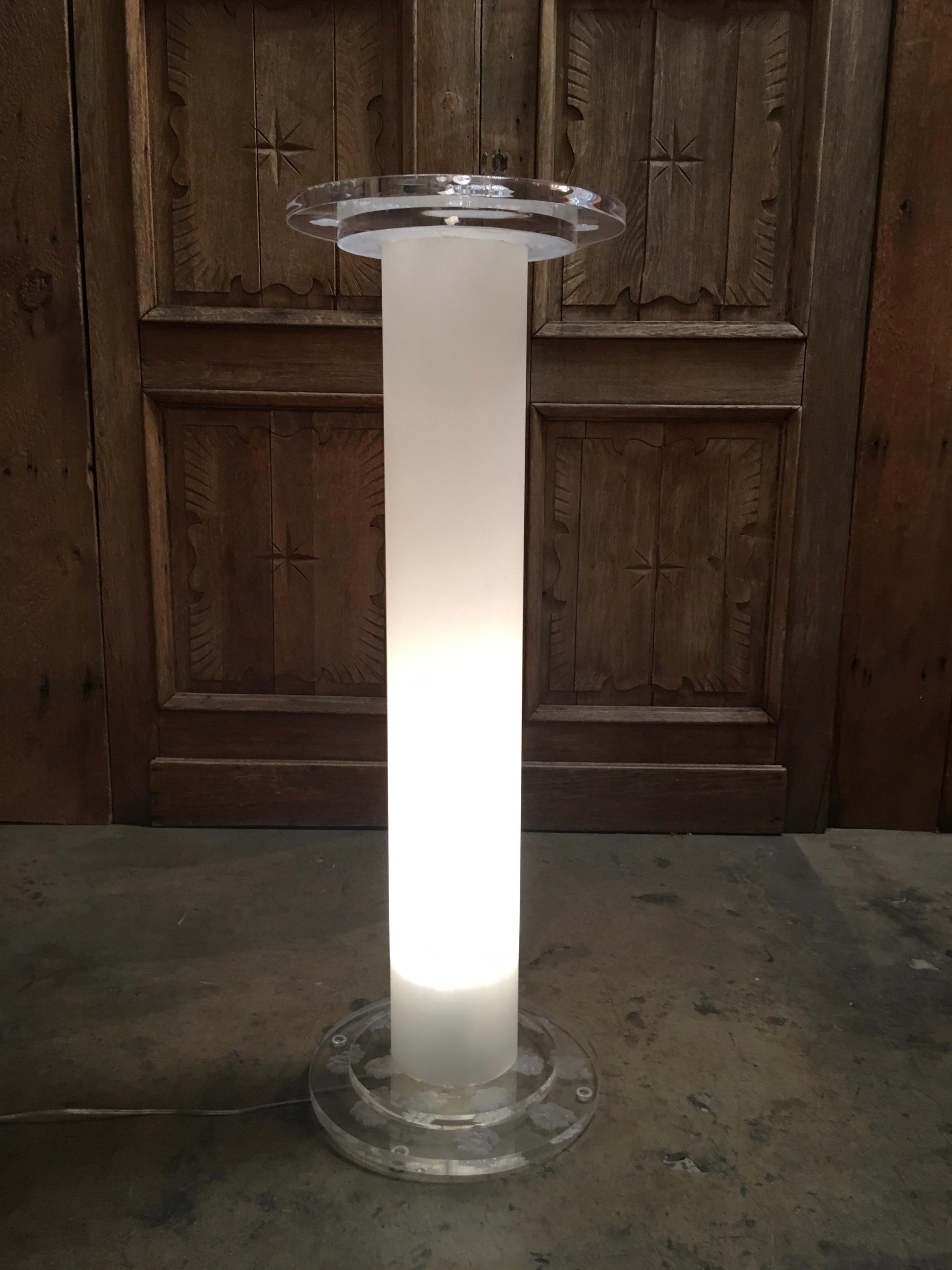 1980s combination of frosted Lucite with sculpted clear Lucite at the top and base and light fixture at base.