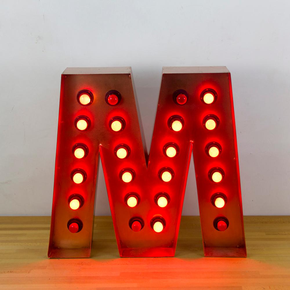 Illuminated marquee letter M from a Springfield clothing brand store in Barcelona, Spain.
Copper color metal frame with 24 E14 type bulbs in red color (4 bulbs are blown/burned).