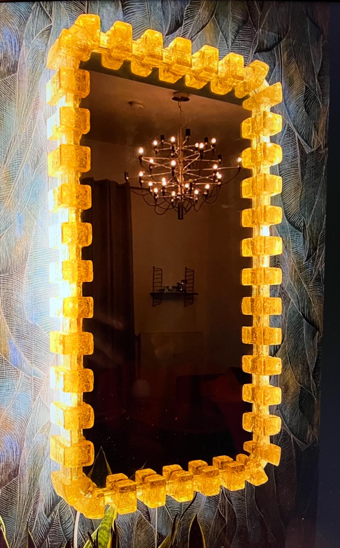 Ein Wandspiegel mit indirekter Beleuchtung vom deutschen Hersteller Hillebrand Lighting. Es wurde in den 1970er Jahren in Deutschland hergestellt. Der Spiegelrahmen ist aus Acryl und der Sockel aus Metall gefertigt. Perfekt für ein Ankleidezimmer,
