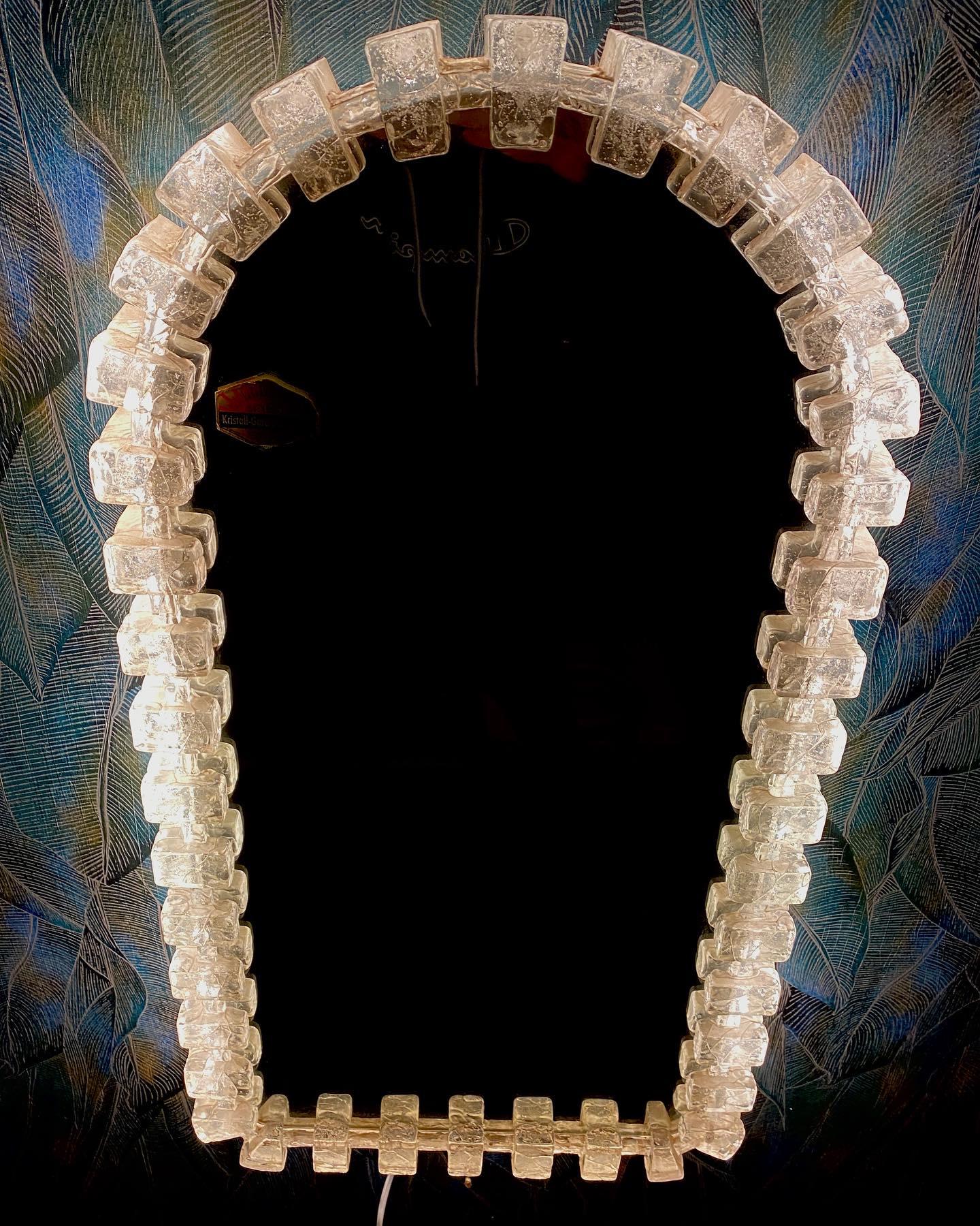 A wall mirror with indirect lighting from the German manufacturer Hillebrand Lighting. It was manufactured in Germany in the 1970s. The mirror frame is made of acrylic and the base is made of metal. Perfect for a dressing room, bedroom, or living