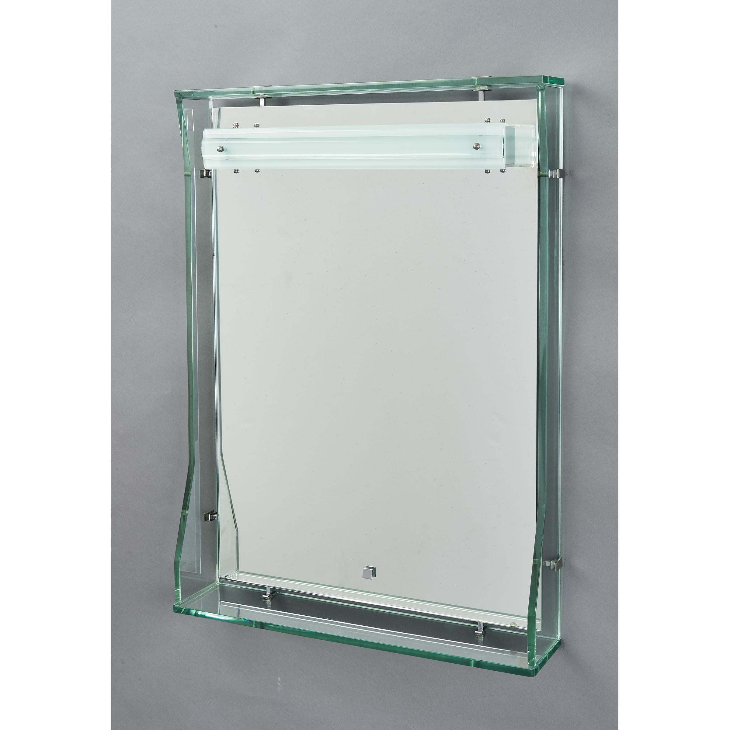 Italy, 1960’s
Illuminated dressing mirror with floating clear glass frame and shelf, in the manner of Fontana Arte,
with overhead LED illumination rewired for use in the USA.
Perfect for a bathroom or entrance
Measures: 31 H x 22 W x 4.5 D.
 
