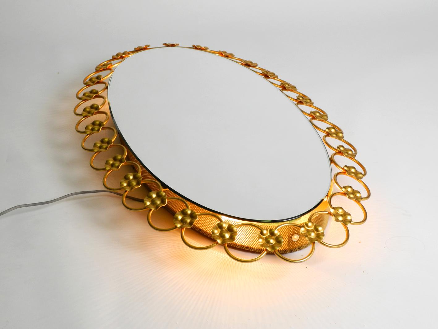 German Illuminated Oval 1960s Large Wall Mirror with a Brass Frame For Sale