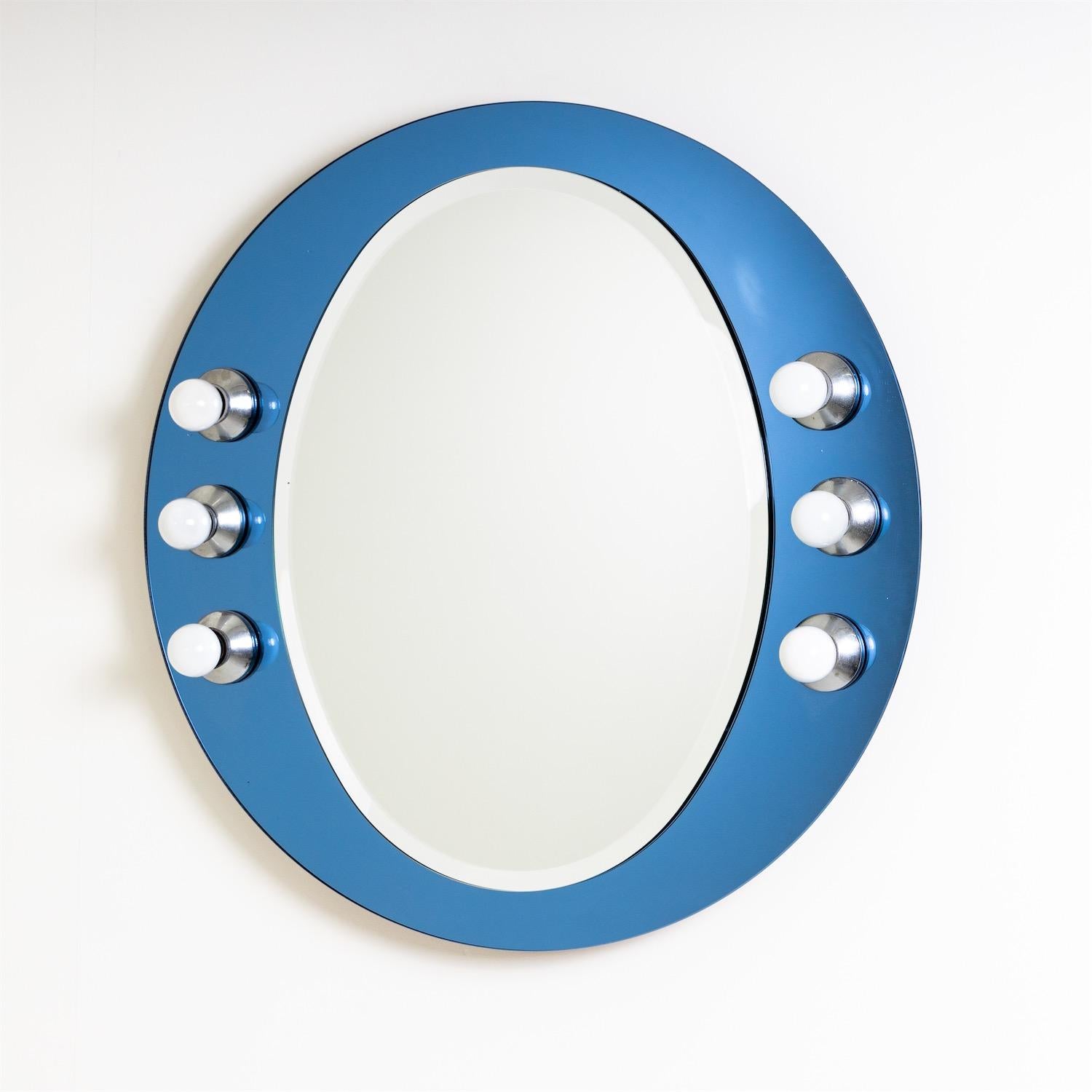 Round illuminated wall mirror of blue glass with six sockets.