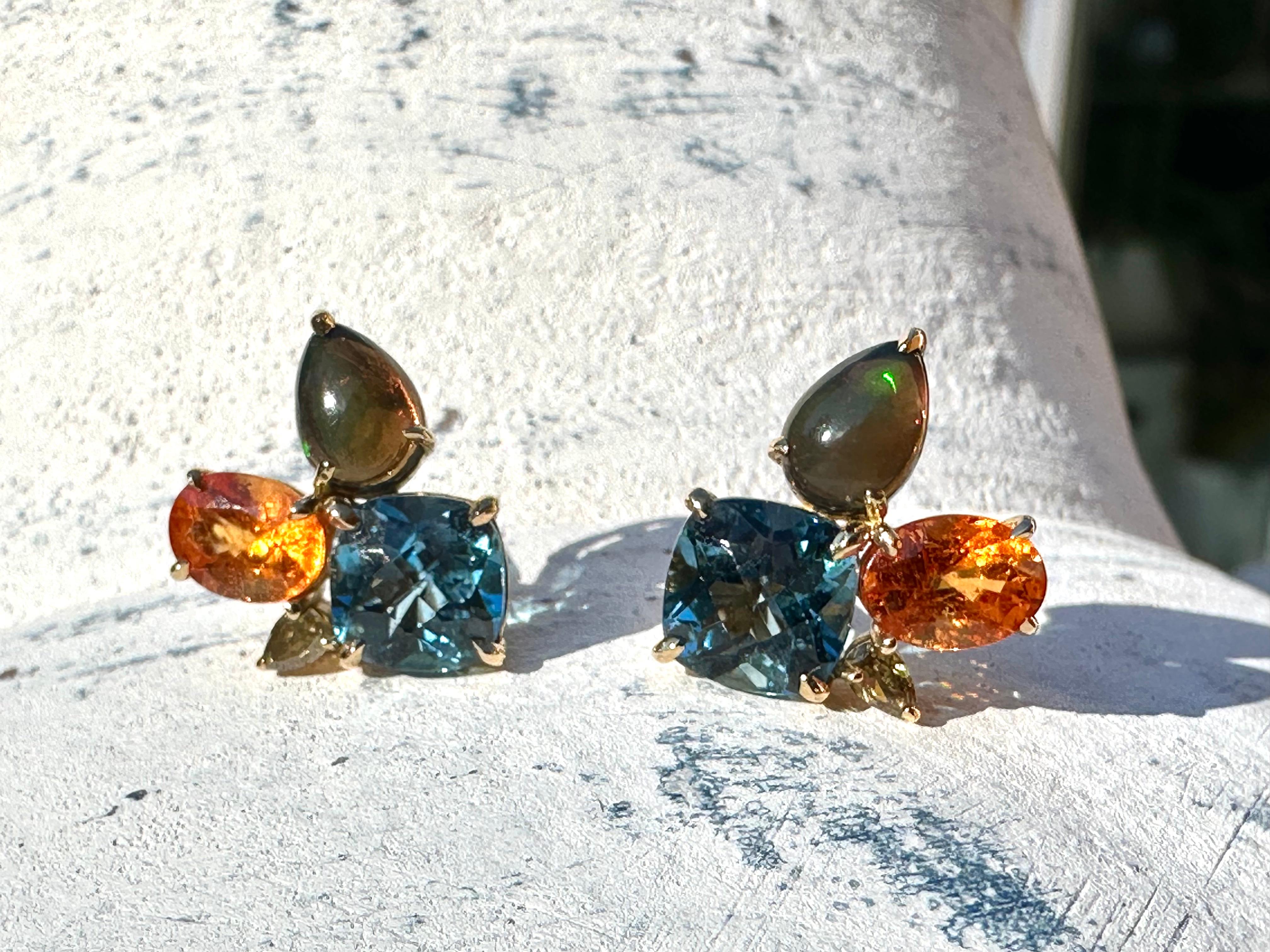 Spessartine Garnet Topaz Black Opal Green Diamond 18k Gold Stud Earrings by Kristin Hanson. This energetic bouquet of gemstones features a black opal enveloped by a colorful London blue topaz and spessartine garnet. The trio is accented by a