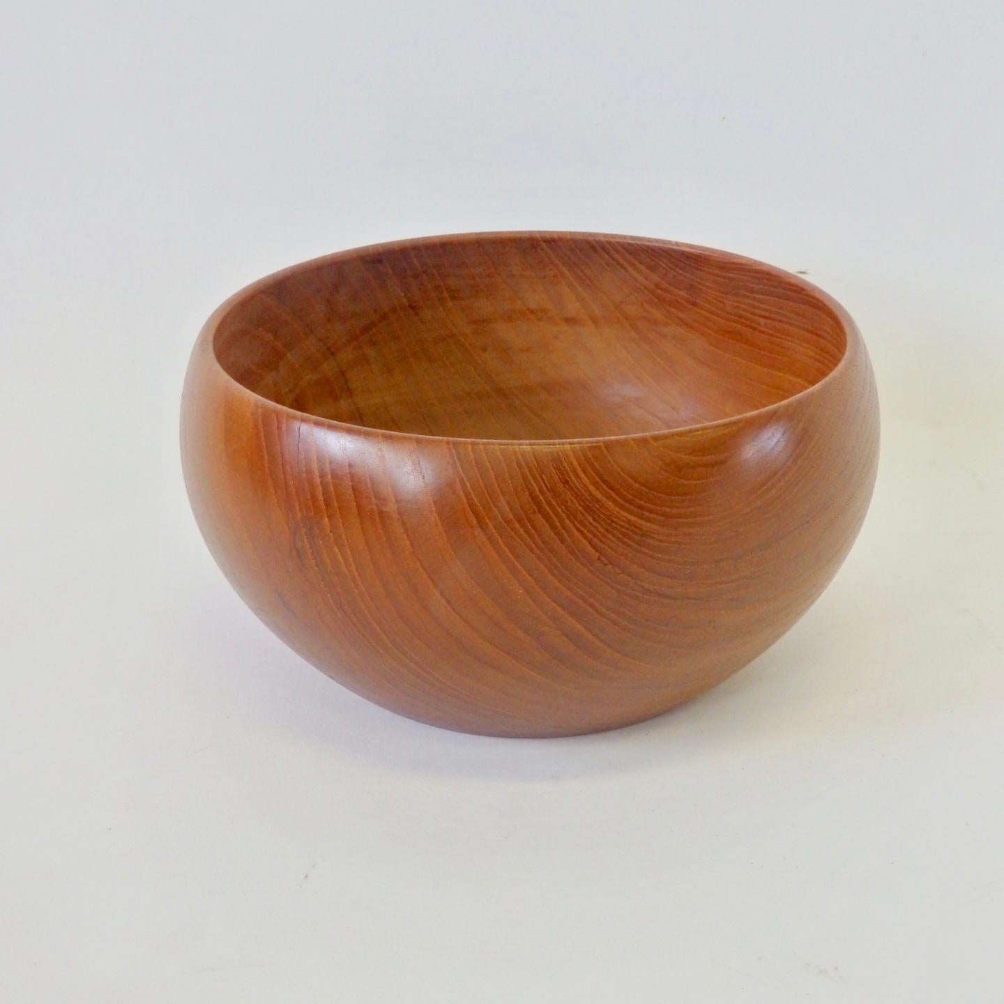 In the style of Kay Bojesen, this turned teak bowl is stamped Illums Bolighus Denmark on the underside. Illums Bolighus, a store with arranged and furnished interiors, where textiles, appointments, and furniture all interacted as art was originally