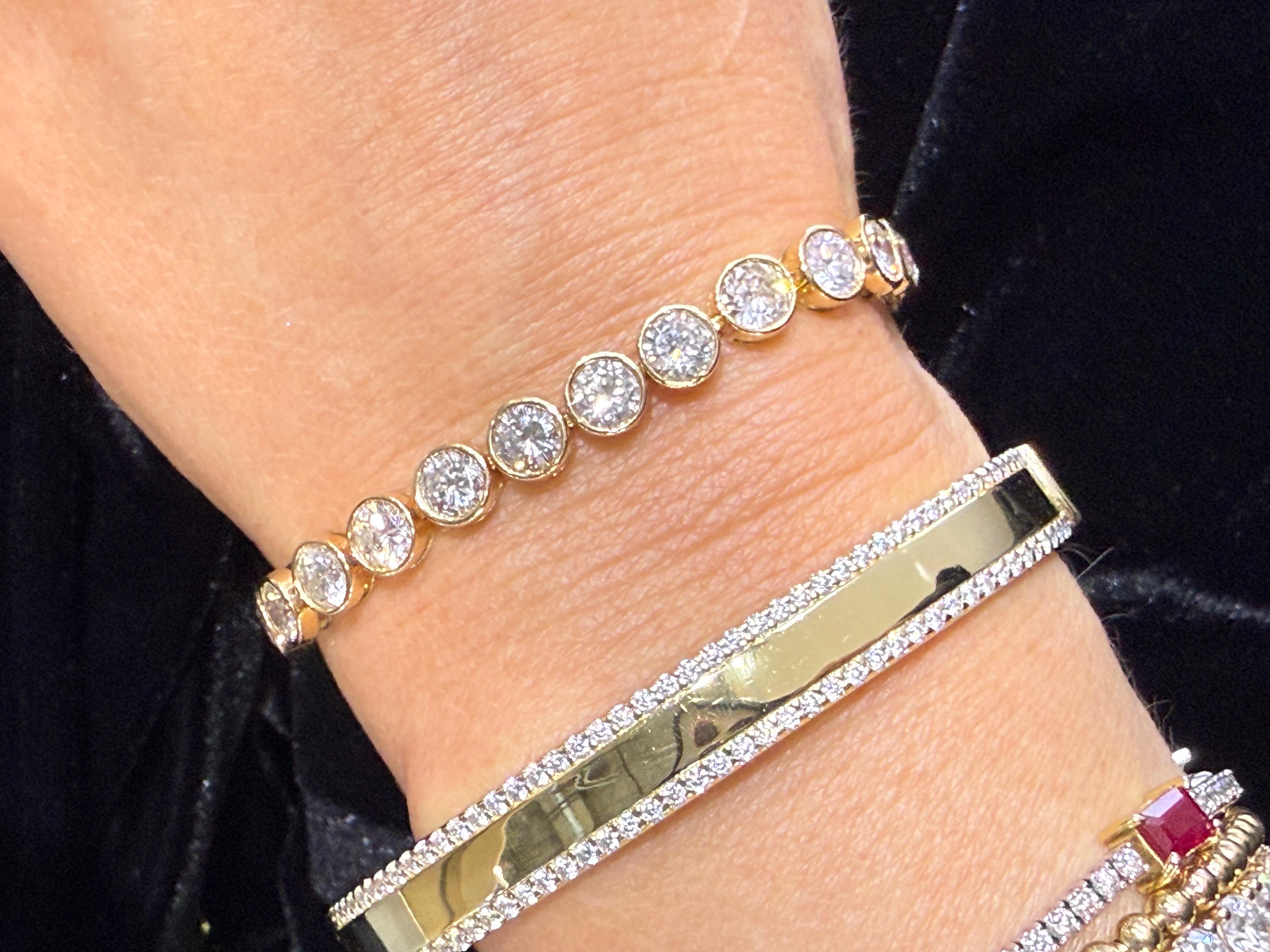 A seamless blend of classic charm and contemporary finesse, the Illusion Line Tennis Bracelet in 14K yellow gold creates the perfect visual brilliance. Each round-cut diamond is expertly set in a mirrored illusion setting, making the stones appear