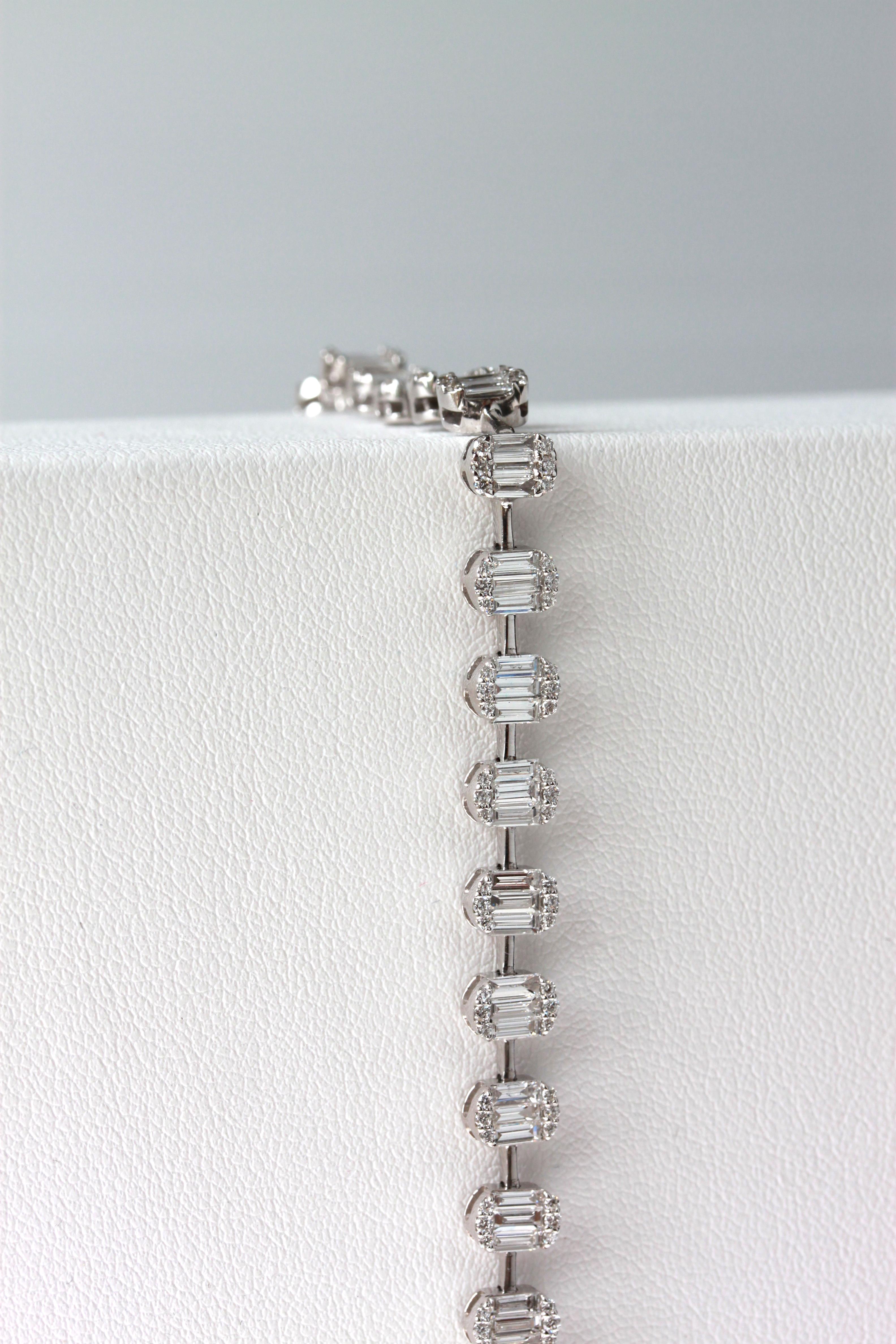 Total Weight: 8.34g
Total Diamond Weight: 3.63ct
Bracelet Length: 16 cm
Height of one illusion oval : 0.59cm

This stunning illusion oval tennis bracelet is the perfect accessory to add a touch of elegance to any outfit. The bracelet is made of