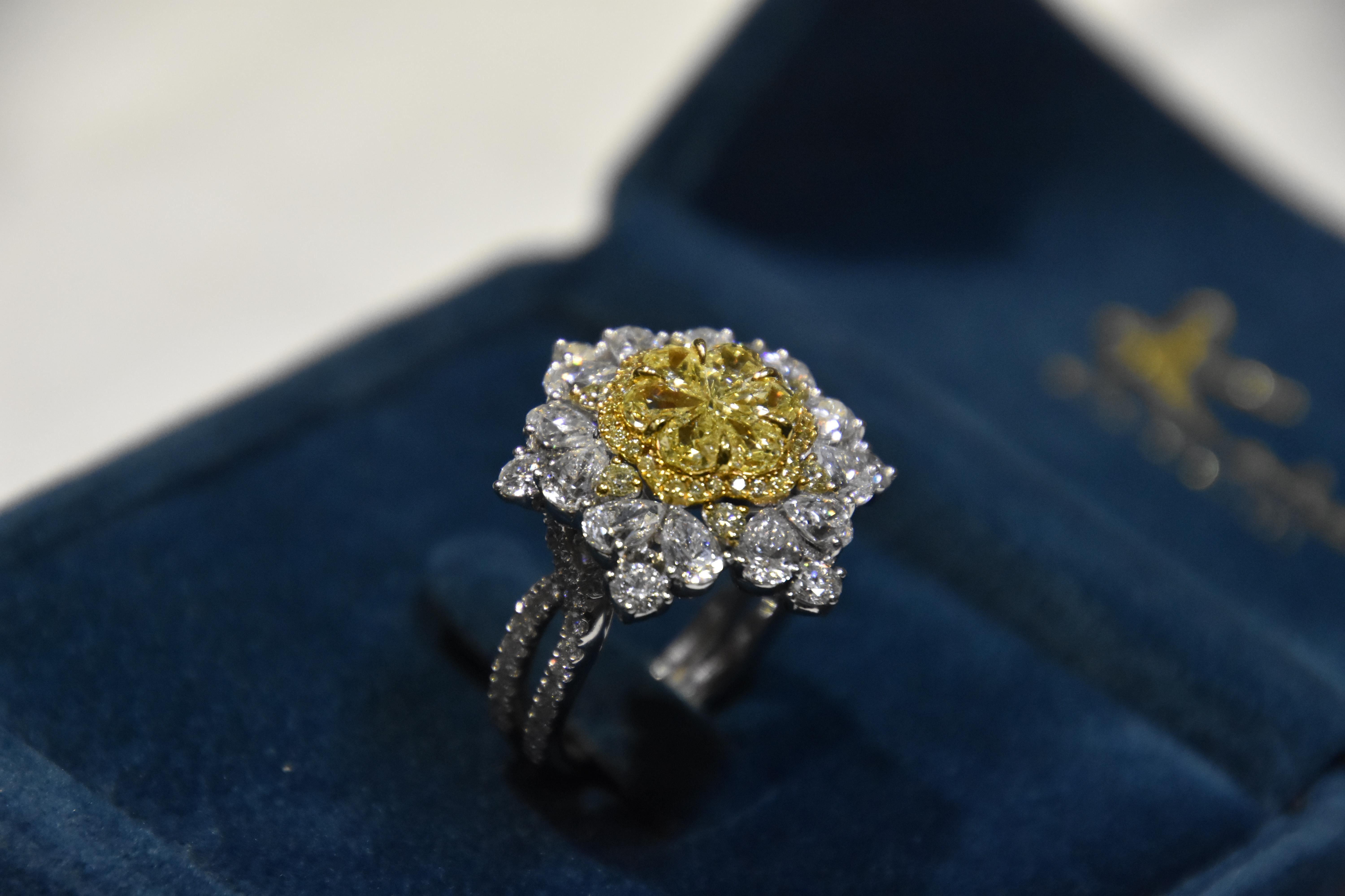 6 pcs of pie cut diamond composed into a Flowery designed ring. A total 1.51 carat Fancy Yellow Diamond with  0.4 carat yellow diamond halo and 4.19 carat white diamond on the outer frame. 

Ring size- US 6.5,   Kahn also provide engraving, resizing