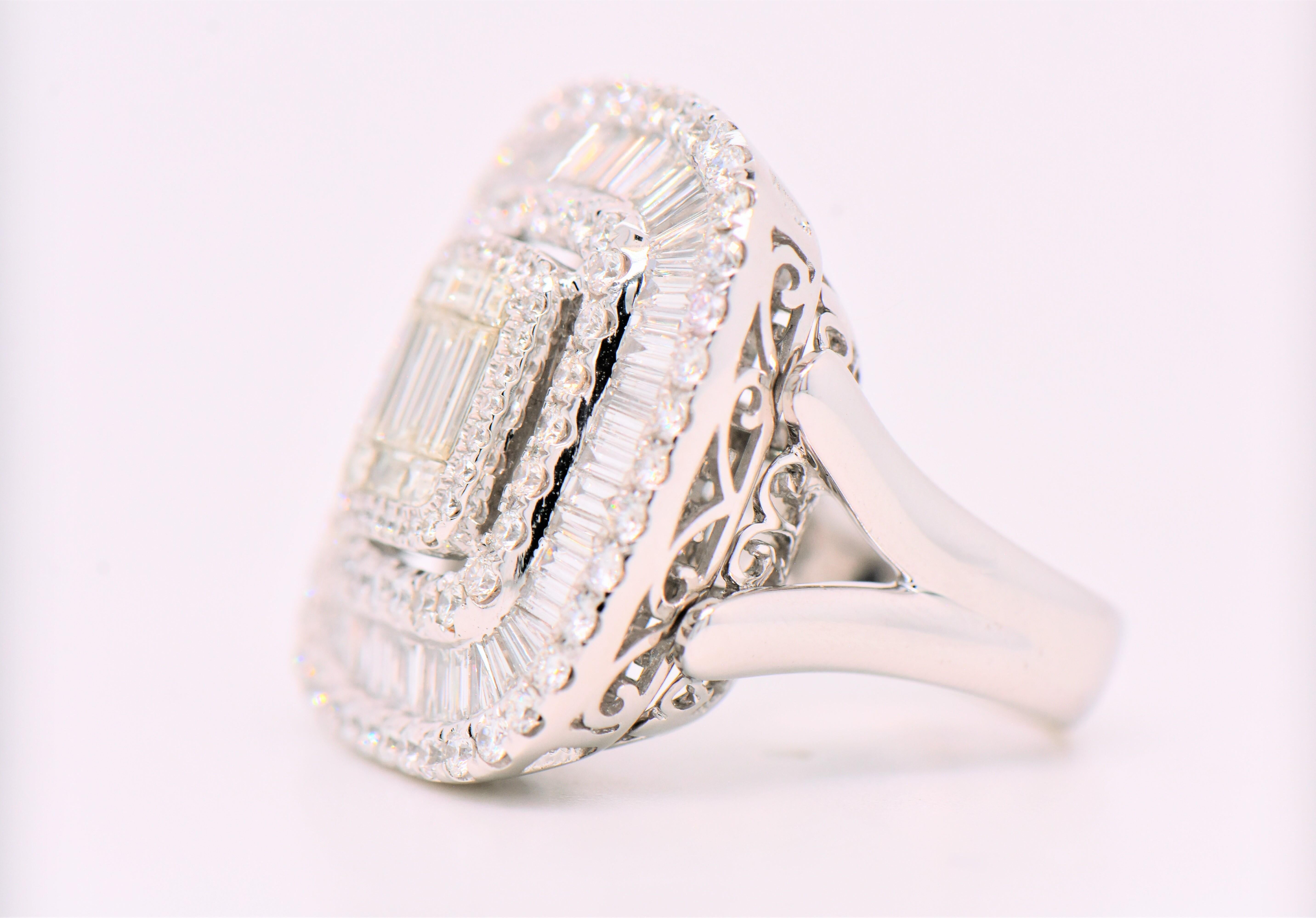 This beautiful Illusion Set white gold engagement ring features a round brilliant-cut diamond weighing 1.98 carats, with VS clarity and G color. The central stone is accented on around sides by a channel-set baguettes diamond. The baguettes weigh