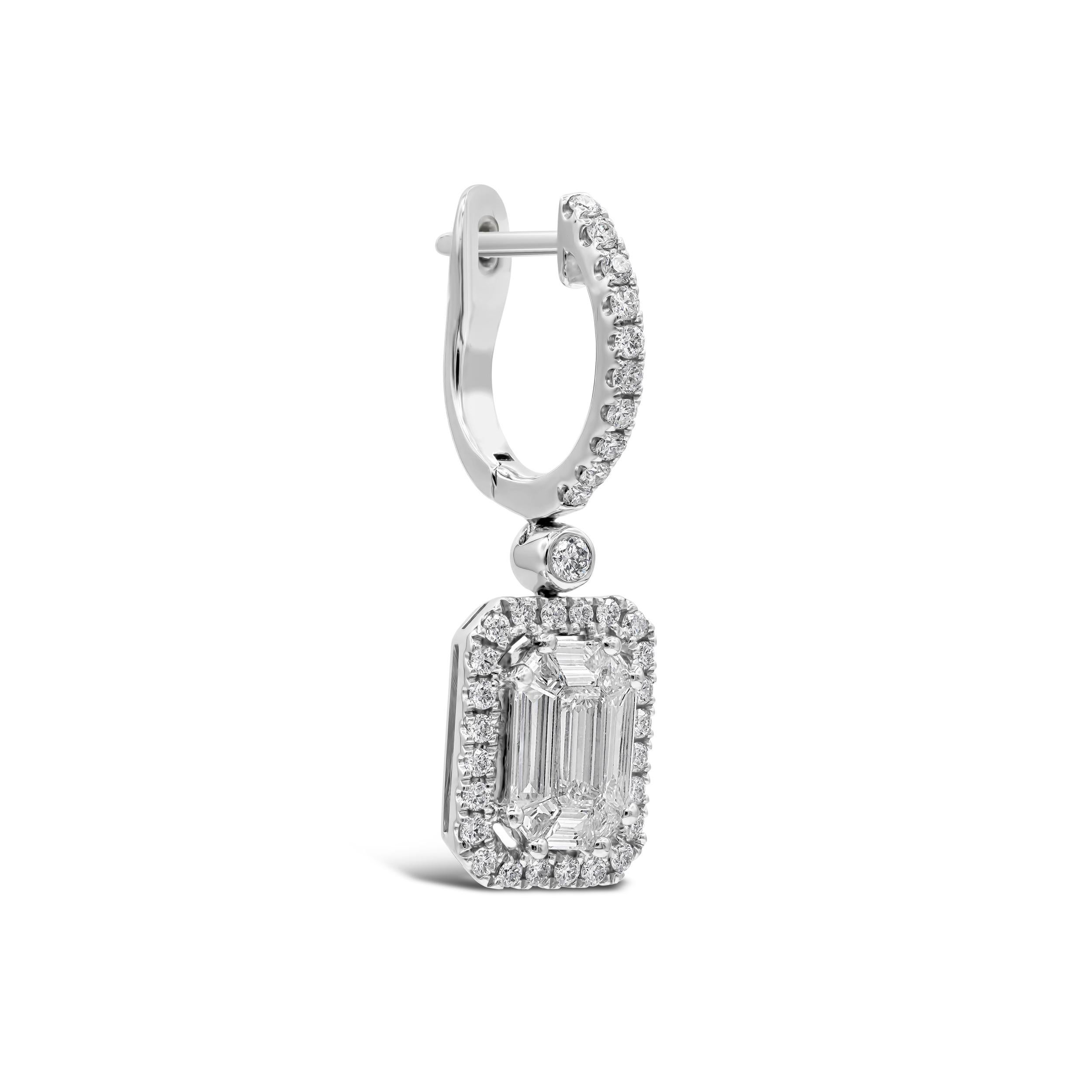 An elegant pair of earrings showcasing baguette and emerald cut diamonds in the center, Invisible set in an illusion design. Surrounded by brilliant round diamonds in a halo design and suspended on a diamond encrusted hoop. Diamonds weigh 1.22