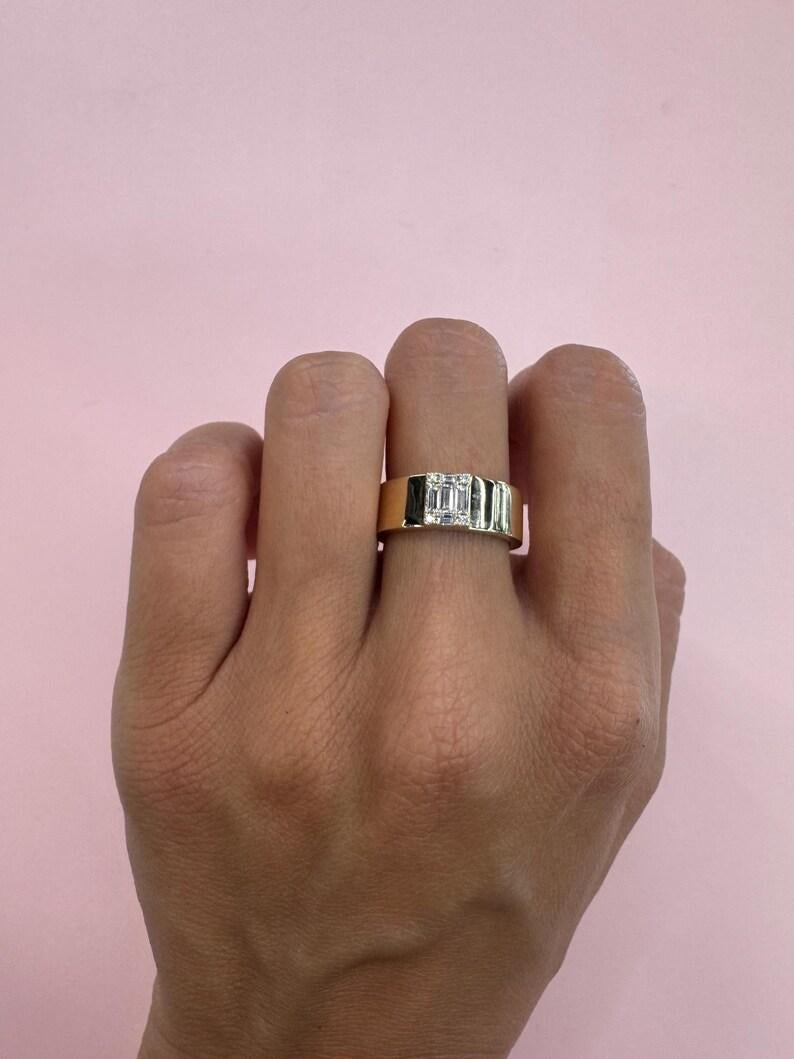 14 Karat yellow gold band featuring an Illusion setting of round and baguette diamonds weighing 0.30 carats, 6.6 MM band. 

More Fashion Rings in Stock. 
Message for Pictures & Details
Search Harbor Diamonds
