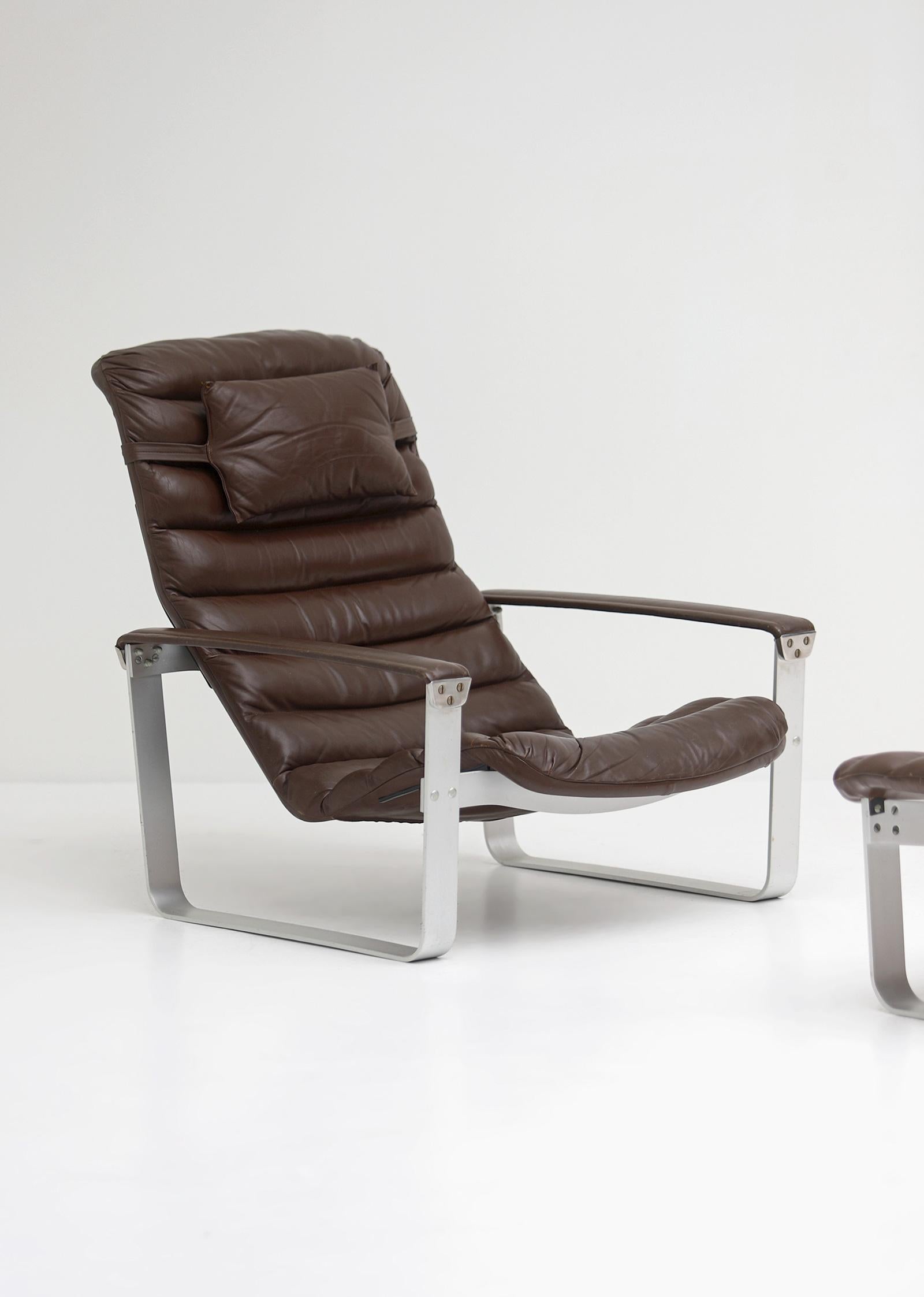 Lounge chair with Ottoman designed by Ilmari Lappalainen For Asko 1960s. Both items have an aluminum base and are upholstered in a chocolate brown leather. The seating is adjustable in three stages and very comfortable. The set comes from the first