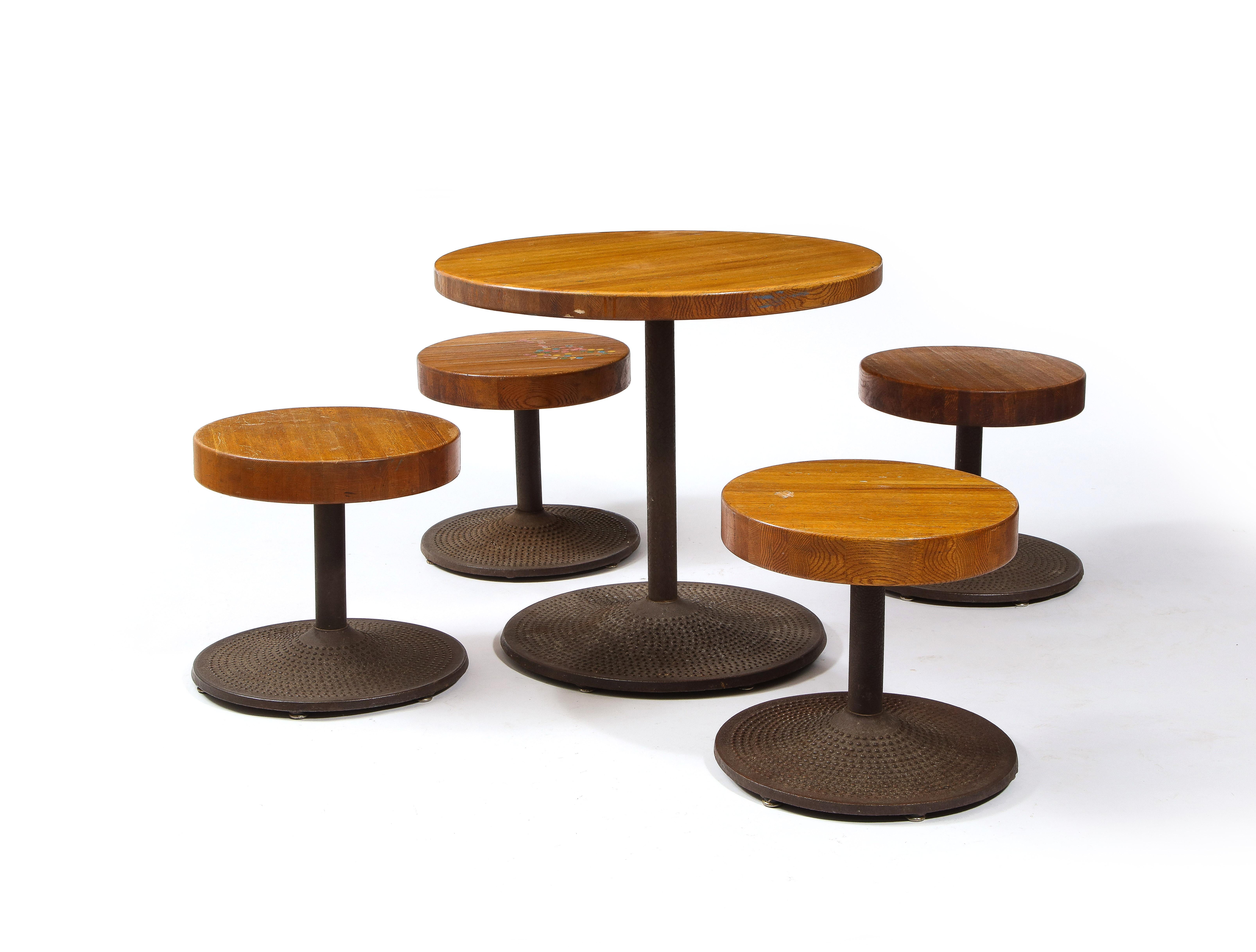 Fantastic set of cast iron and oak stool and table, the bases are solid steel with a dimple motif while the tops are solid oak, the design bears similarity to a Perriand model for Les Arcs.