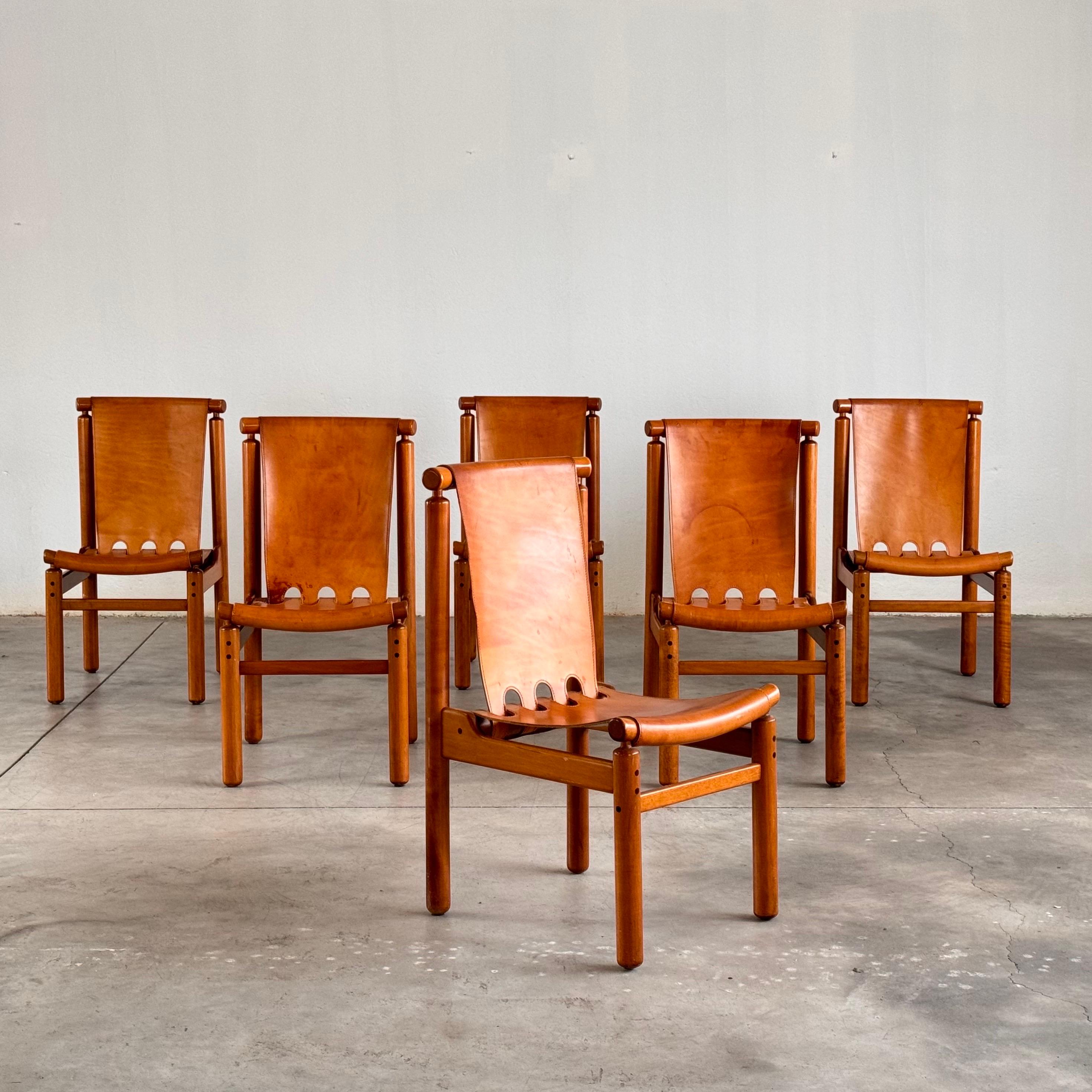 Step into the timeless elegance of mid-century Italian craftsmanship with this impeccable set of six Ilmari Tapiovaara dining chairs, meticulously crafted by La Permanente Cantù circa 1950. Each chair is a testament to the marriage of form and