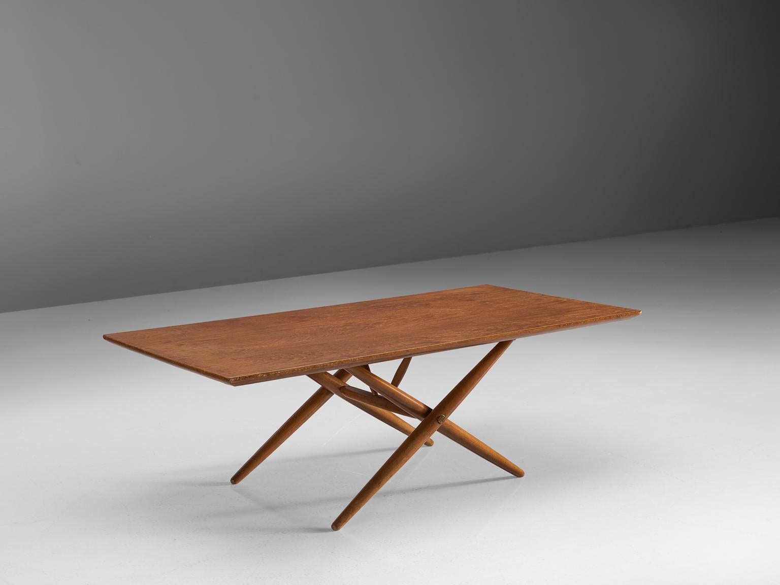 Ilmari Tapiovaara for Asko, 'Domino' coffee table, birch, Finland, 1953.

This Finnish coffee table is designed by Ilmari Tapiovaara. The table features a solid rectangular tabletop and a cross-legged base with legs that are tapered towards both