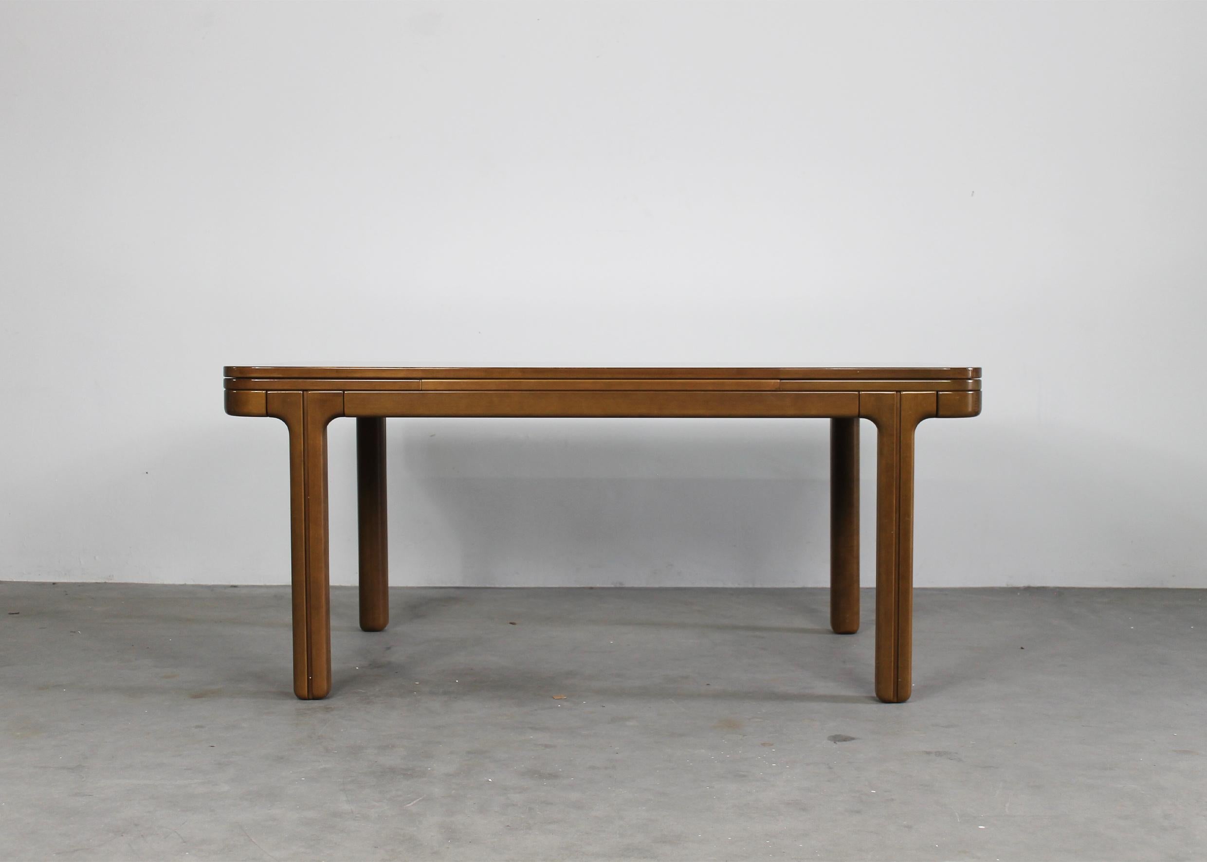 Extendable dining table in wood designed by Ilmari Tapiovaara in the 1970s. 

This rare table presents a rectangular top with elegant rounded edges. The table top fits to the base with an interlocks system. The two lateral wings can add more space
