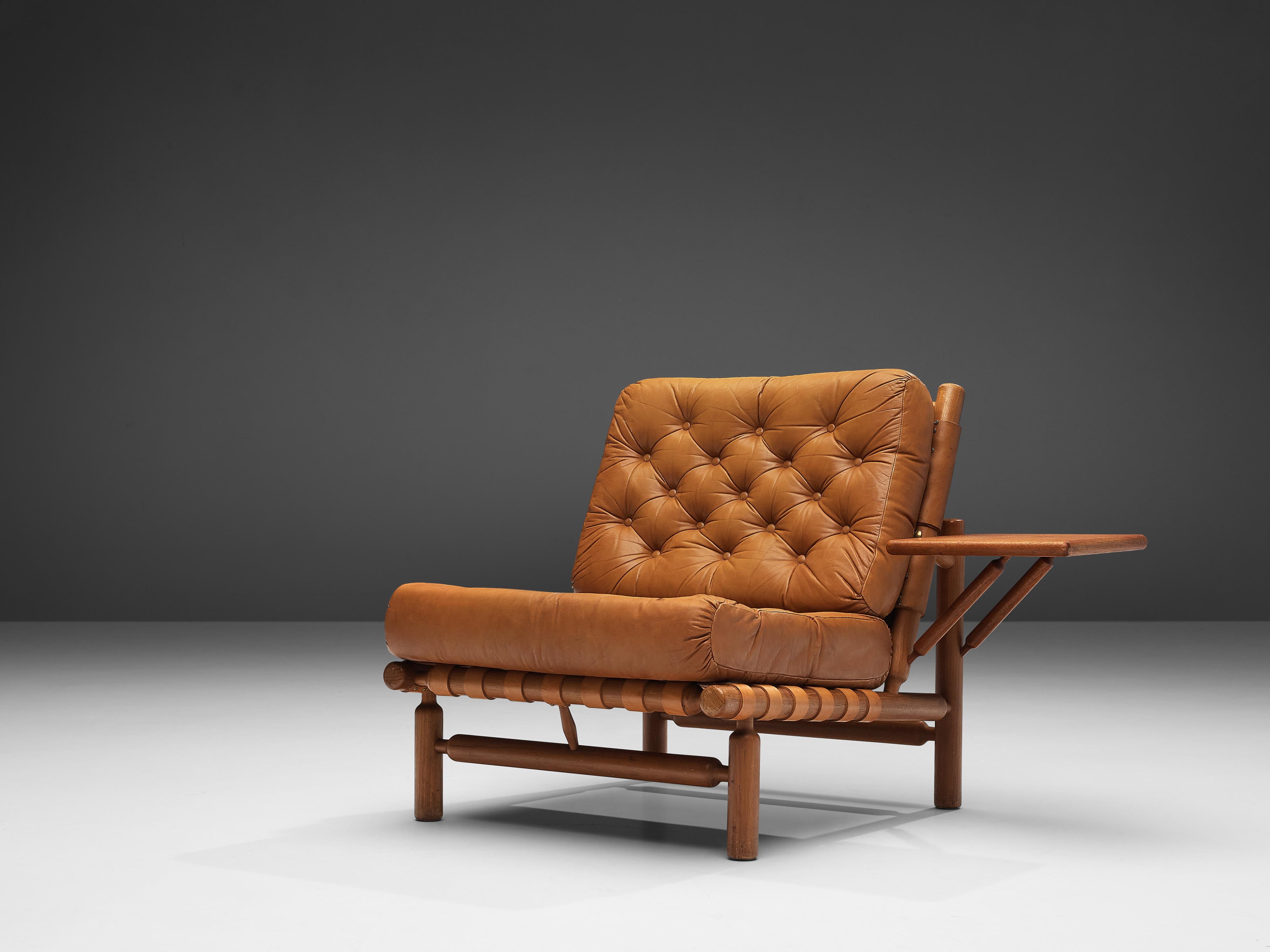 Ilmari Tapiovaara for Esposizione La Permanente Mobili, lounge chair with ottoman, teak and leather, Finland, 1957. 

Lounge chair with ottoman by Finnish designer Ilmari Tapiovaara. This organic design features beautiful patinated leather support
