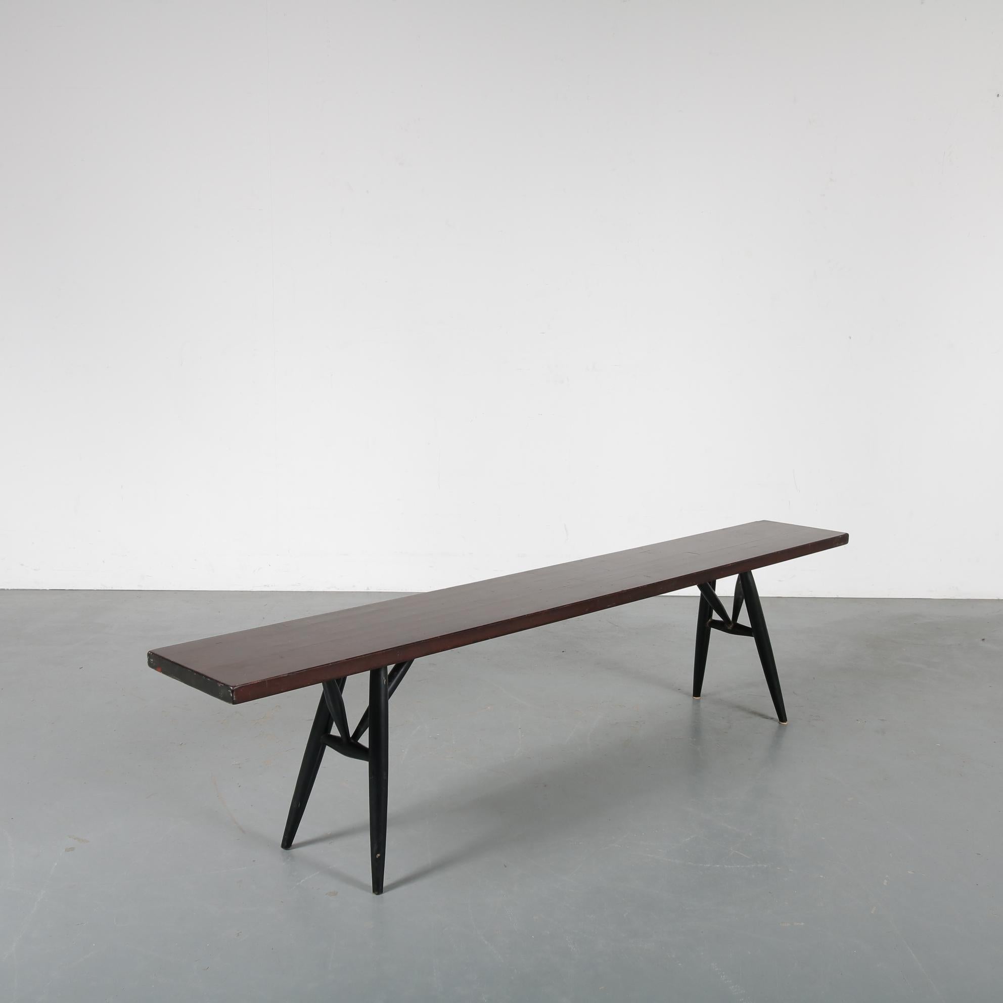 A wonderful bench from the “Pirkka” series, designed by Ilmari Tapiovaara and manufactured by Laukaan Puu, circa 1950.

The narrow rectangular top / seat of the bench are made of dark stained pine wood and it has a black lacquered wooden base.