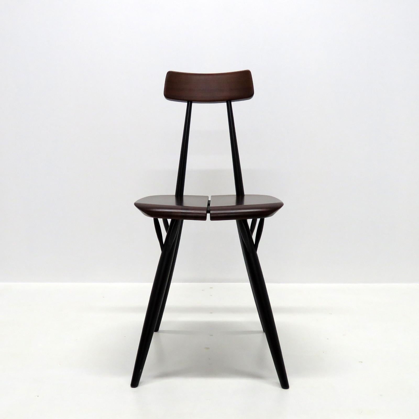 Wonderful chairs designed by Ilmari Tapiovaara for Laukaan Puu, Finland 1955 in dark stained pinewood and black lacquered dowel legs, marked. Priced individually.