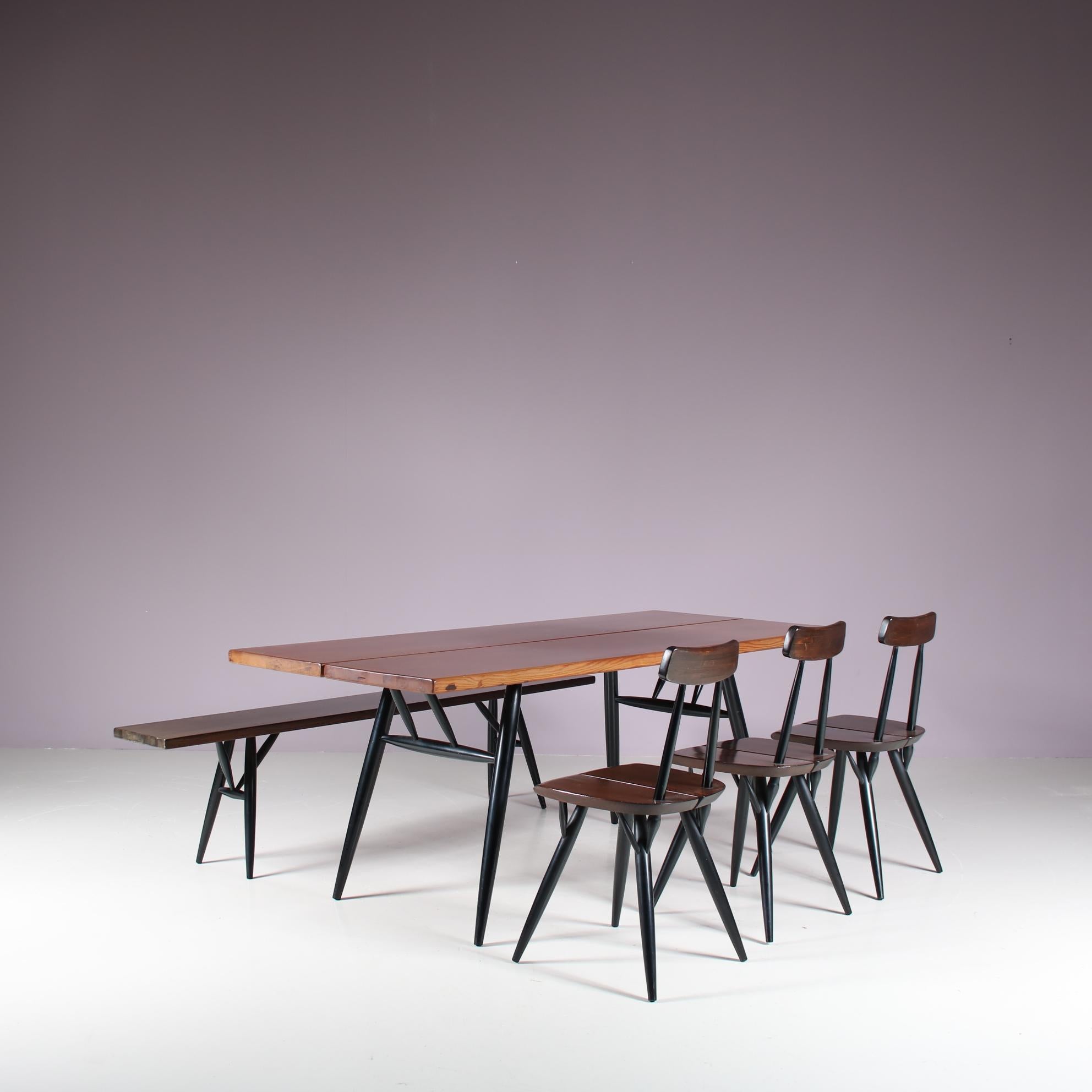 An outstanding “Pirkka” dining set designed by Ilmari Tapiovaara, manufactured by Laukaan Puu in Finland around 1950.

This impressive set contains one table, three chairs and one bench, all made from the highest quality pine wood with a warm brown