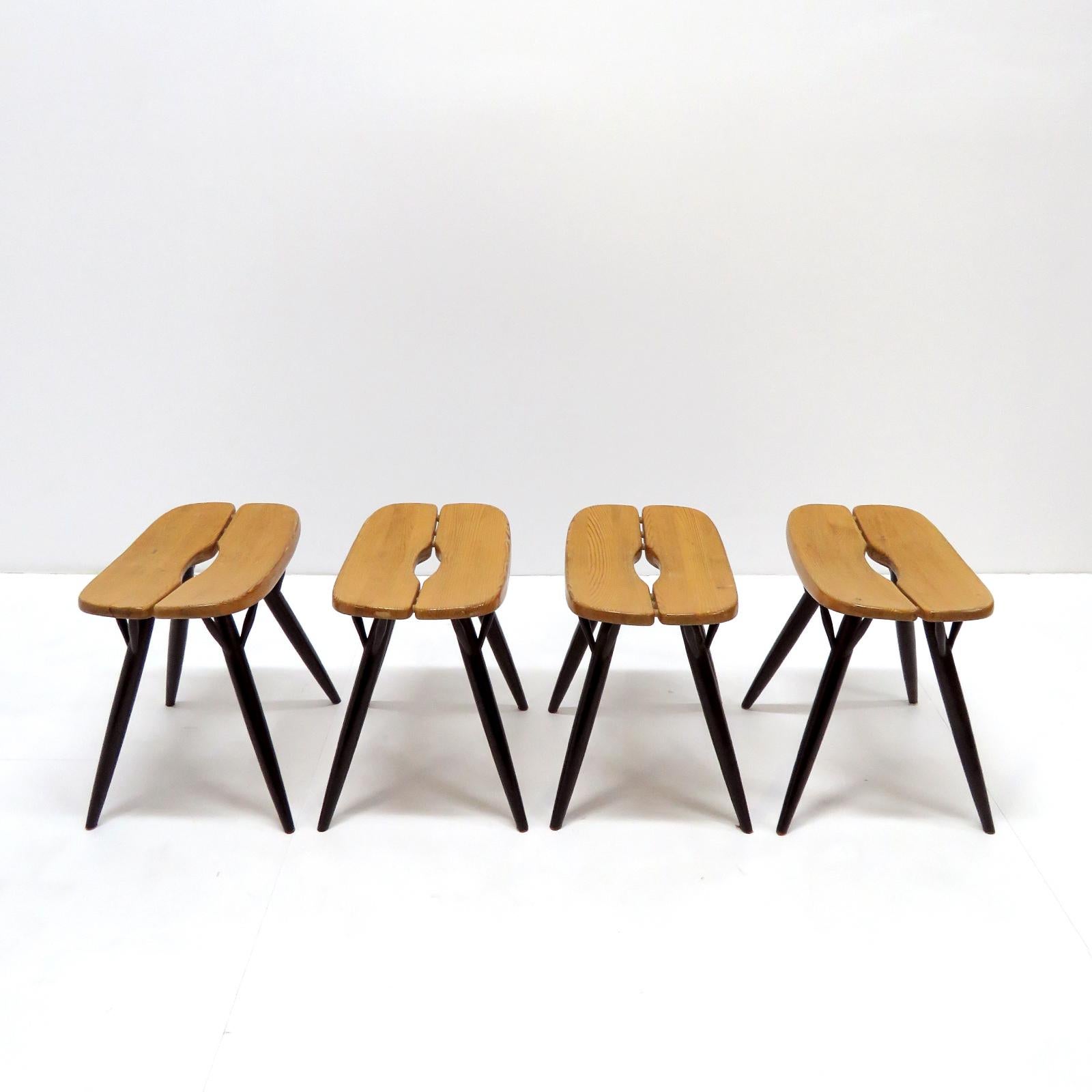 Wonderful stools designed by Ilmari Tapiovaara for Laukaan Puu, Finland 1955 in pinewood and black lacquered dowel legs, marked, priced individually.