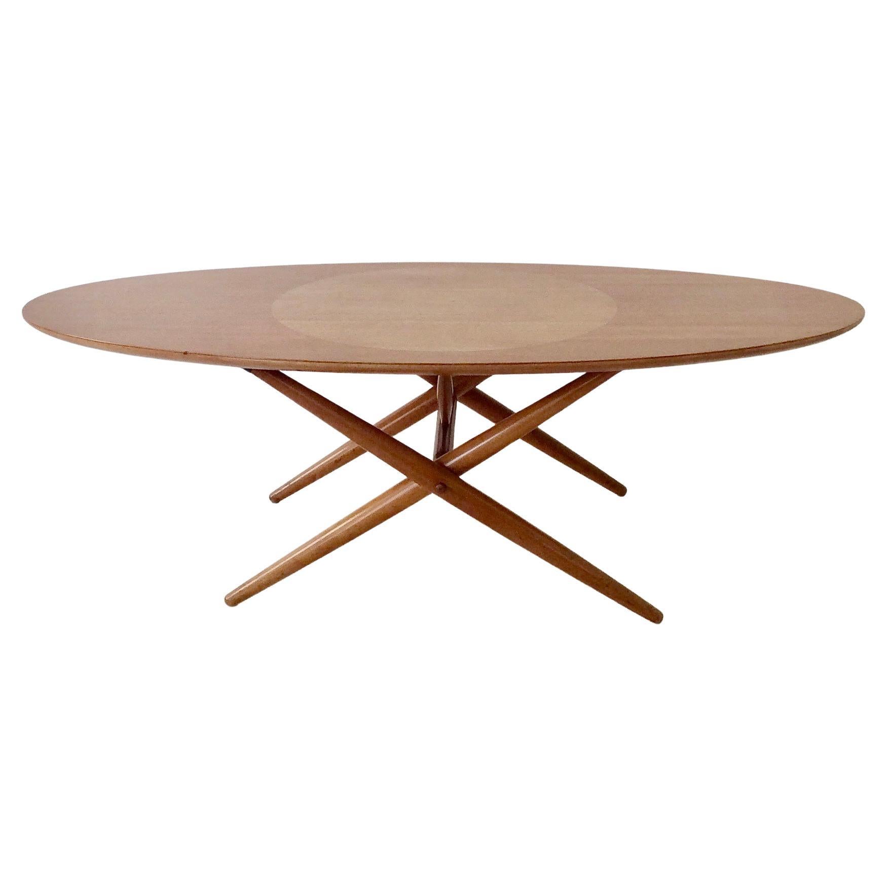 Rare version of Ovalette model coffee table by Ilmari Tapiovaara for Asko Oy Lahti, circa 1954, Finland.
Beech table top with large birch circle inlay. 
 Solid wood crossed-legged.
Dimensions: 120 cm W, 60 cm D, 40 cm H.
Good original condition,
