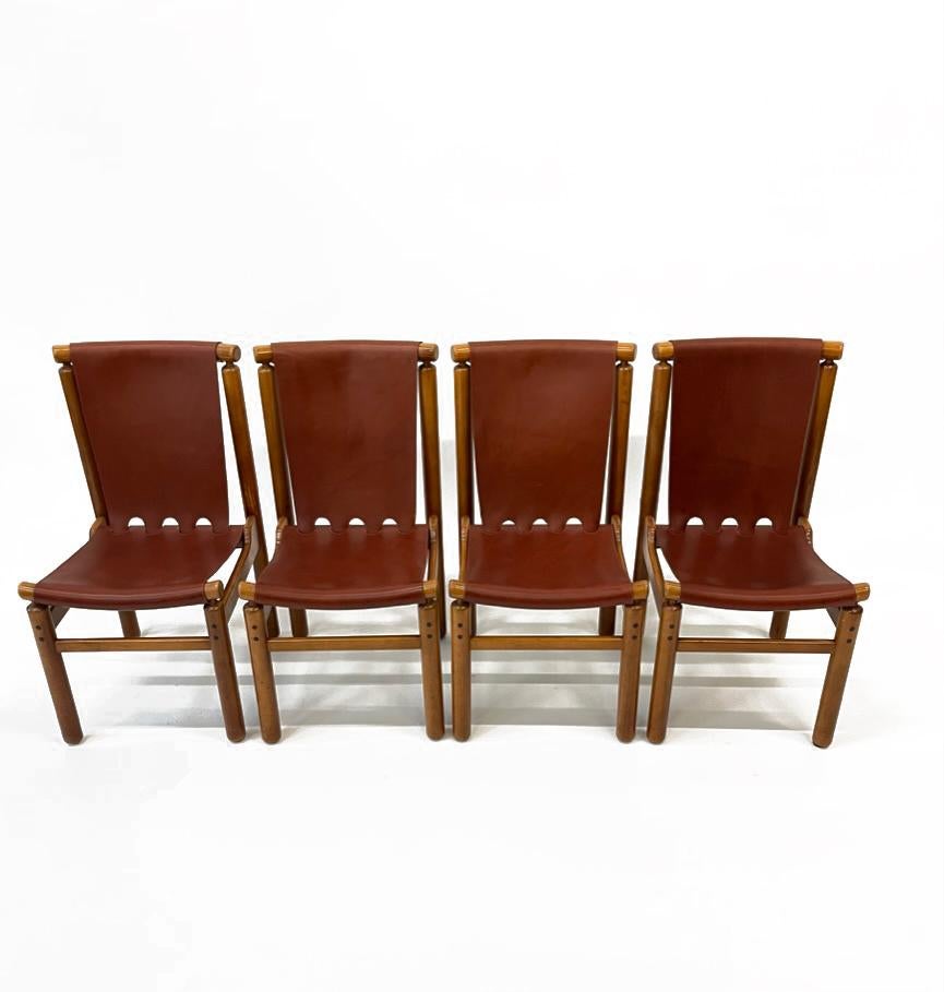 Ilmari Tapiovaara for La Permanente Mobili Cantù, darkened beech and patinated cognac leather, Finland, 1950s. These robust chairs by Ilmari Tapiovaara feature a geometric frame for the patinated cognac leather seating and backrest. Besides the rich