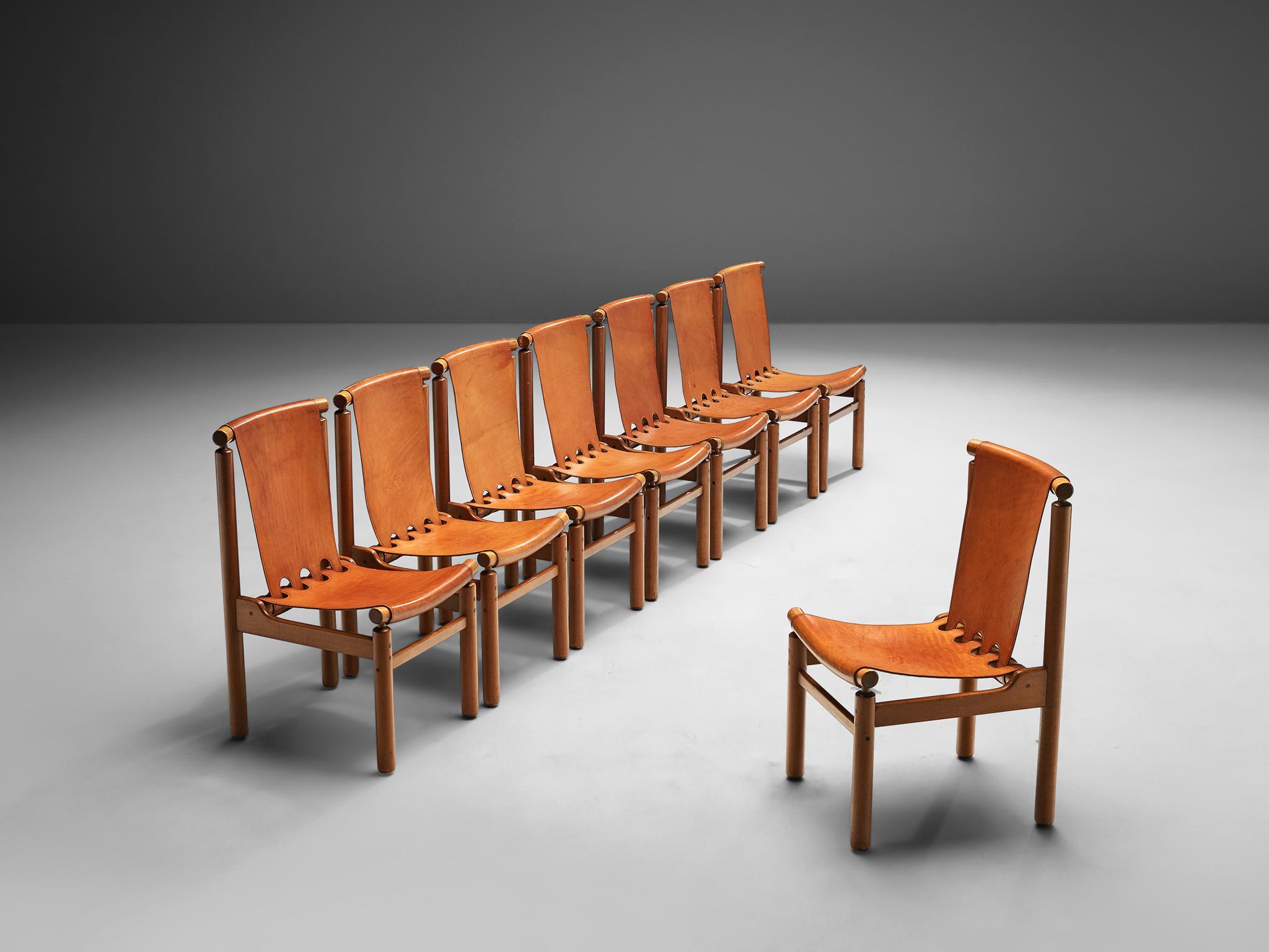 Ilmari Tapiovaara for La Permanente Mobili Cantù, darkened beech and patinated cognac leather, Finland, 1950s.

These robust chairs by Ilmari Tapiovaara feature a geometric frame for the patinated cognac leather seating and backrest. Besides the