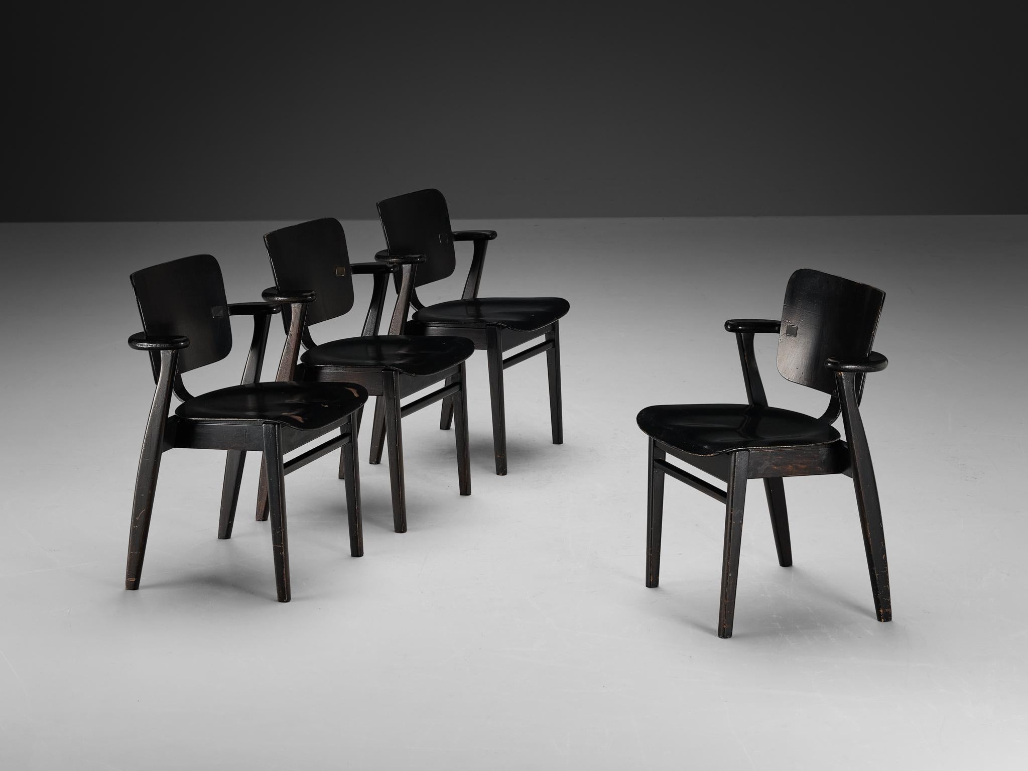 Ilmari Tapiovaara, set of four armchairs, stained teak, metal, Finland, 1953

This is a wonderful set of early ‘Domus’ armchairs by Finnish designer Ilmari Tapiovaara. Executed in a black color, the framework includes laminated teak plywood. This