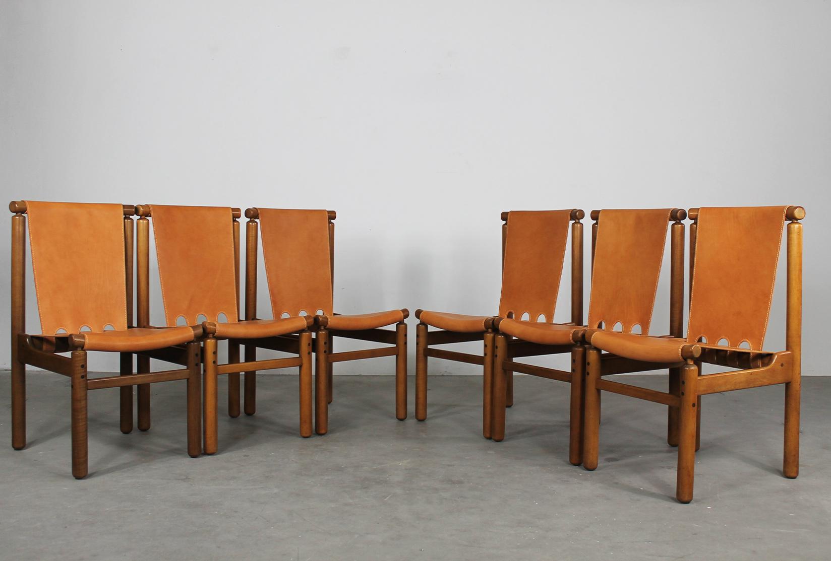 Set of six dining chairs with wooden frame, seat and back in leather designed by Ilmari Tapiovaara and produced by La Permanente Mobili Cantù in 1950s. 

This set of chairs presents a beautiful solid structure given by the geometrical shape of the