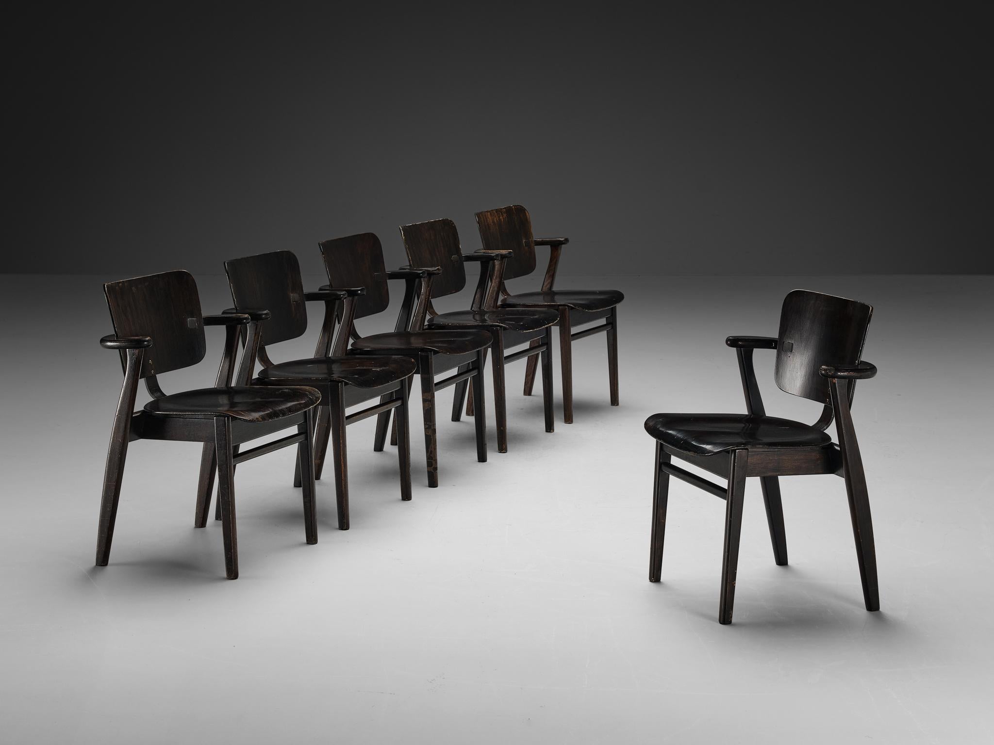 Ilmari Tapiovaara, set of six armchairs, stained teak, metal, Finland, 1953

This is a wonderful set of early ‘Domus’ armchairs by Finnish designer Ilmari Tapiovaara. Executed in a black color, the framework includes laminated teak plywood. This