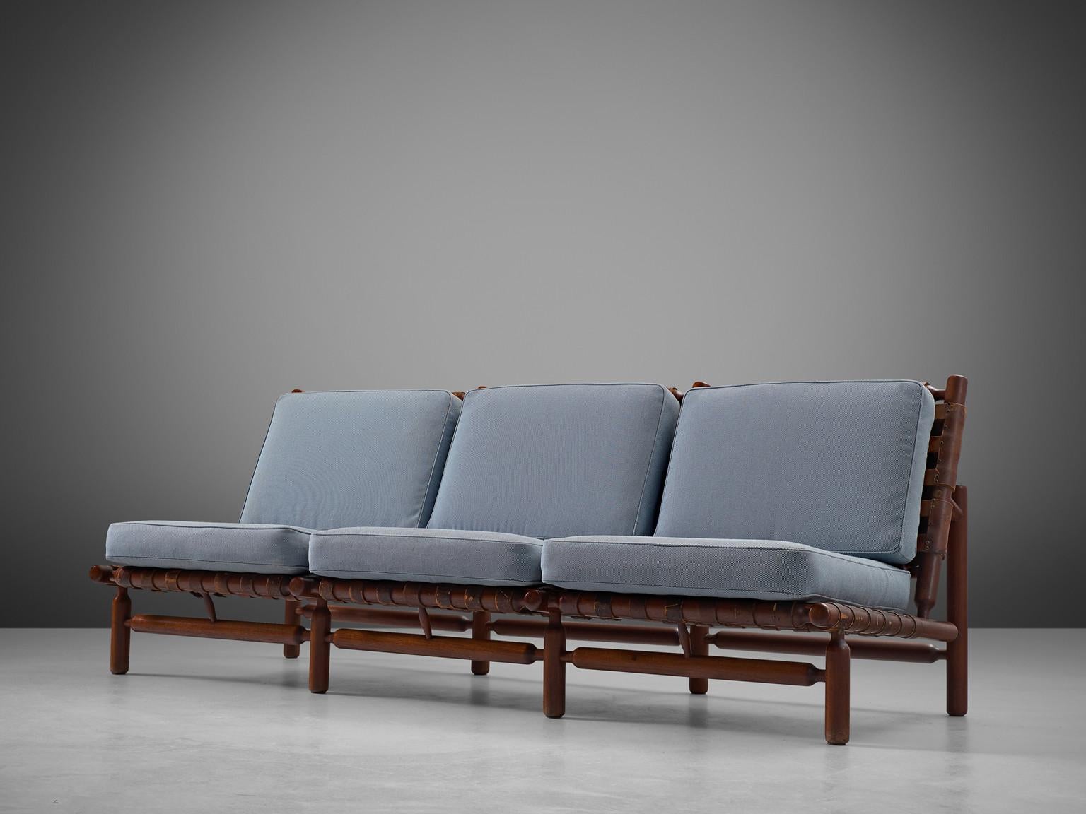 Ilmari Tapiovaara for Esposizione La Permanente Mobili manufactured by Paolo Arnaboldi, sofa, teak, leather, brass, fabric, Italy, 1957. 

This three-seat sofa is designed by Finnish designer Ilmari Tapiovaara and was presented at the artisan