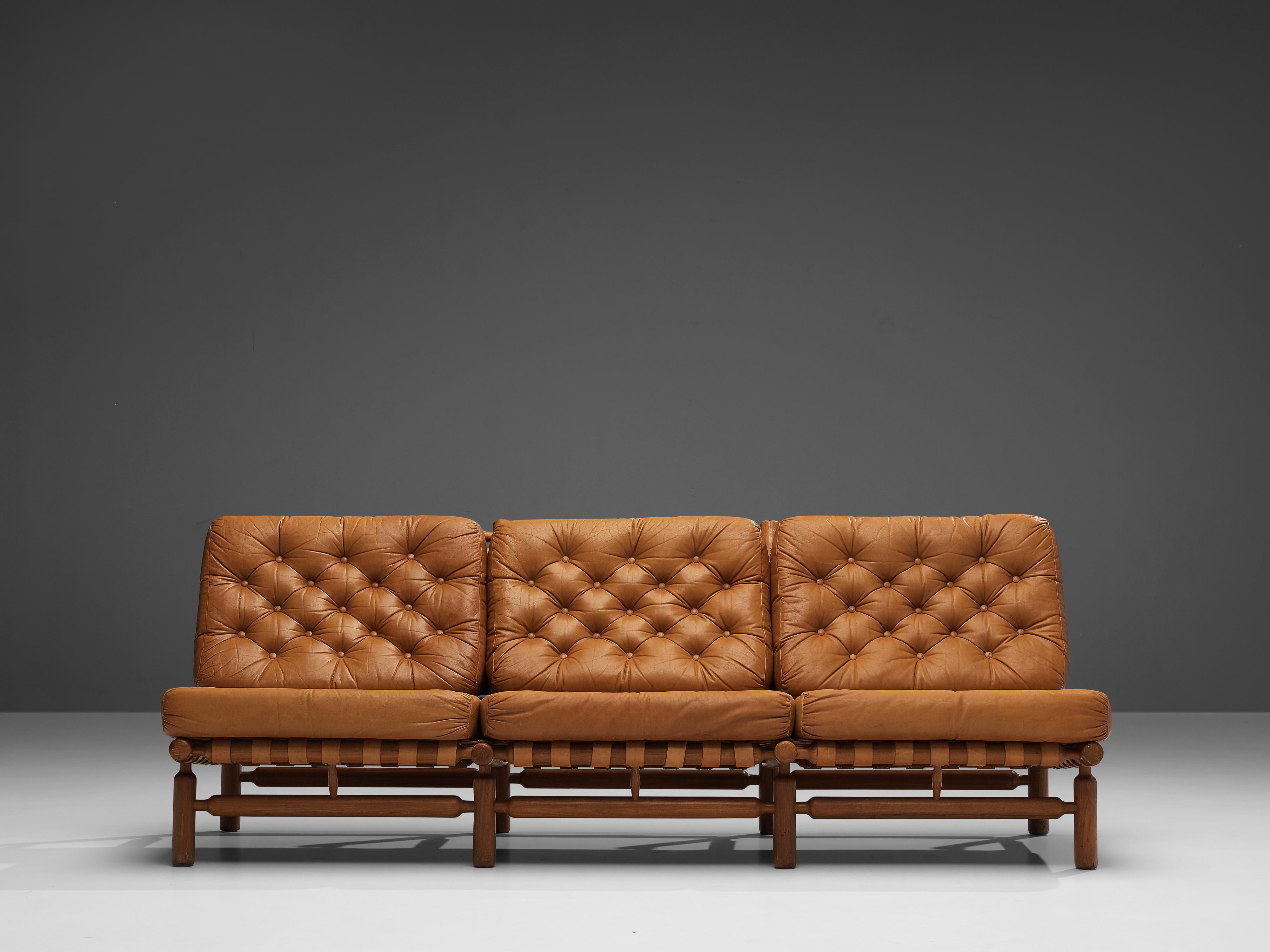 Ilmari Tapiovaara for Esposizione La Permanente Mobili, sofa, teak and leather, Finland, 1957. 

Three seat sofa by Finnish designer Ilmari Tapiovaara. This organic design features beautiful patinated leather support strapping within a teak frame