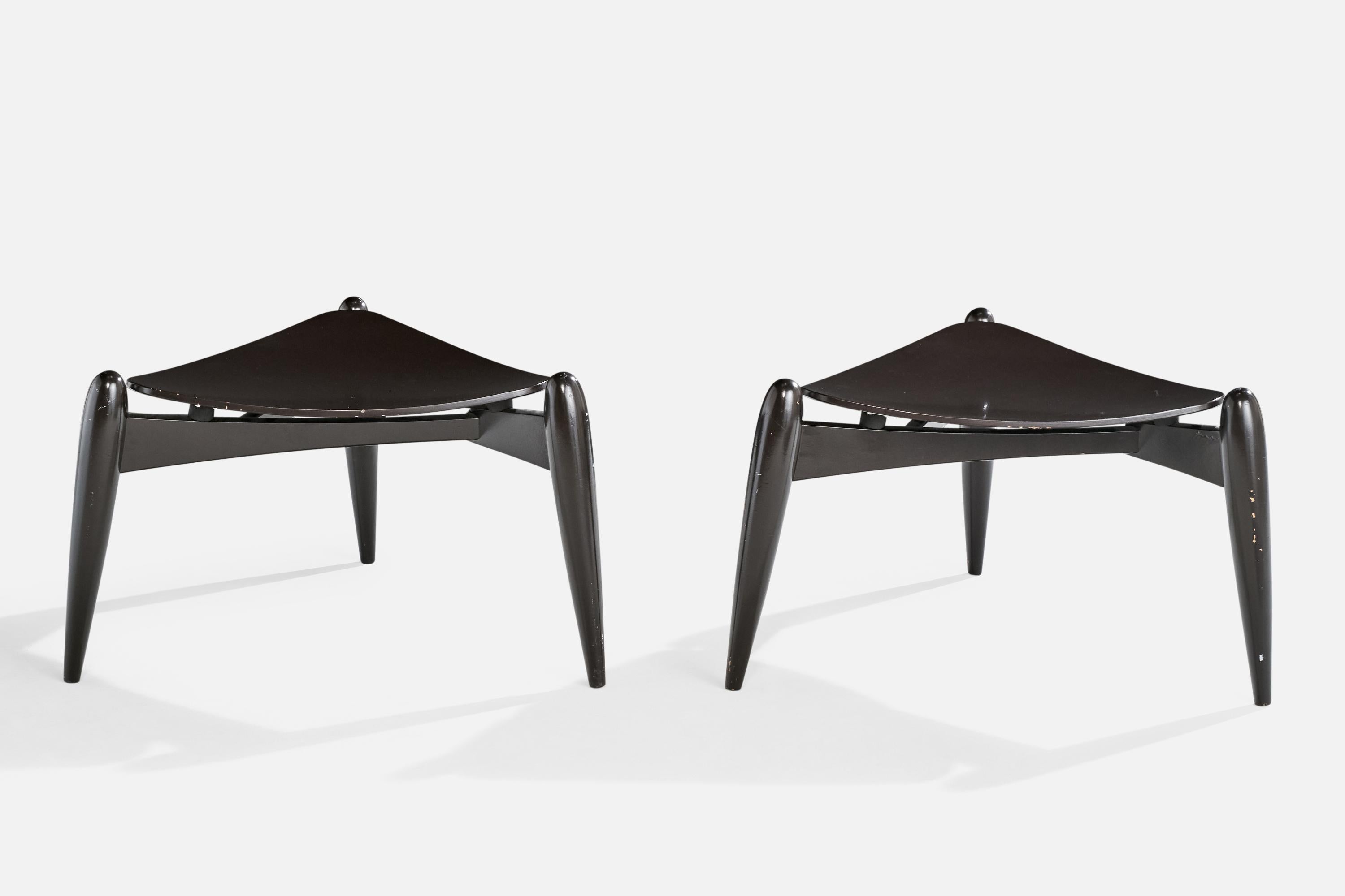 A pair of black-painted birch plywood stools designed by Ilmari Tapiovaara in 1953 and produced by Aero, Finland, c. 1990s.

Patina and small losses present to lacquer.

Dimensions: 15.75” H x 23” Diameter
