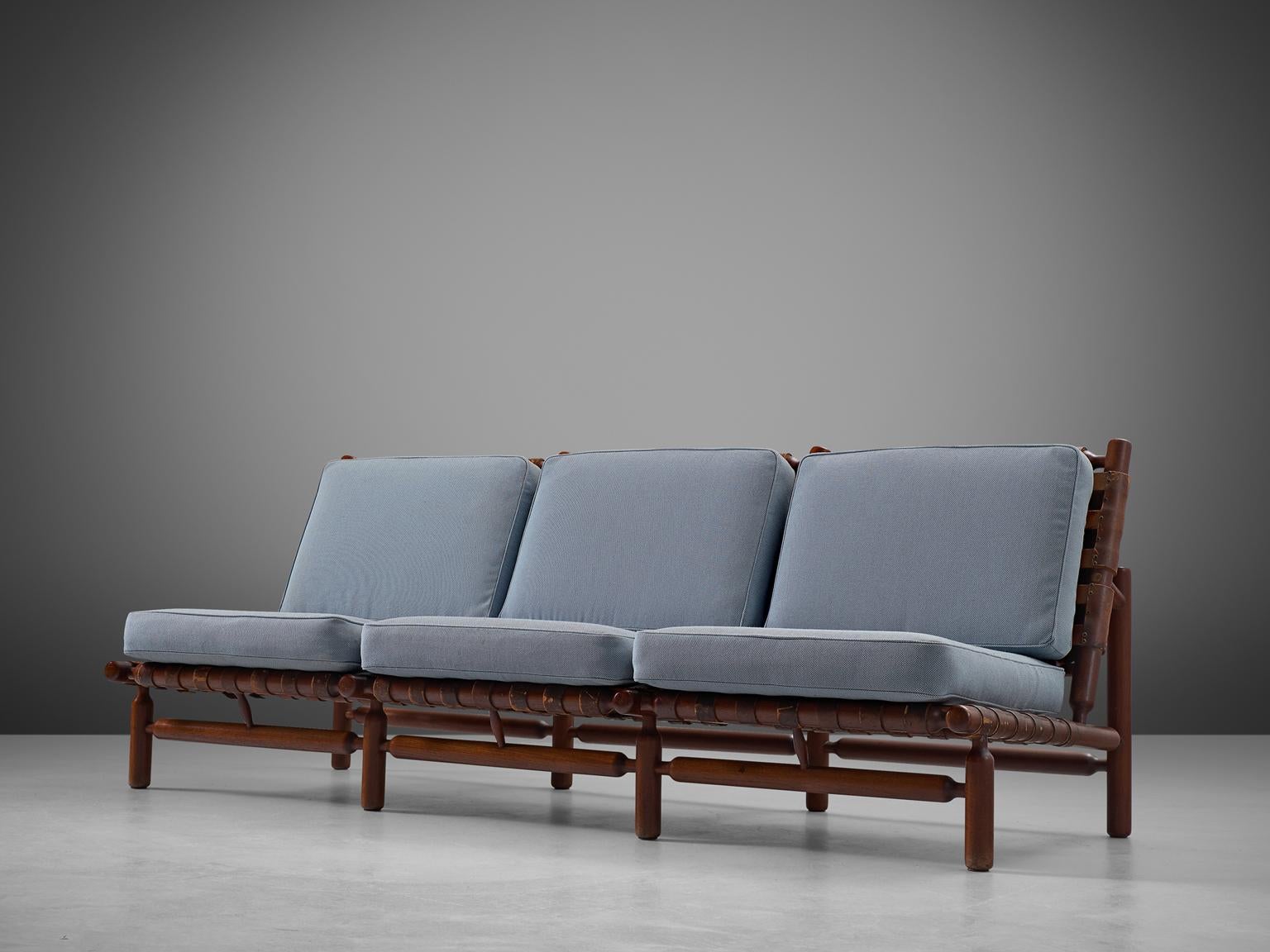 Sofa and lounge chair, in teak and leather, by Ilmari Tapiovaara for Esposizione La Permanente Mobili manufactured by Paolo Arnaboldi, Italy, 1957. 

This rare three-seat sofa and lounge chair by Finnish designer Ilmari Tapiovaara (1914-1999).