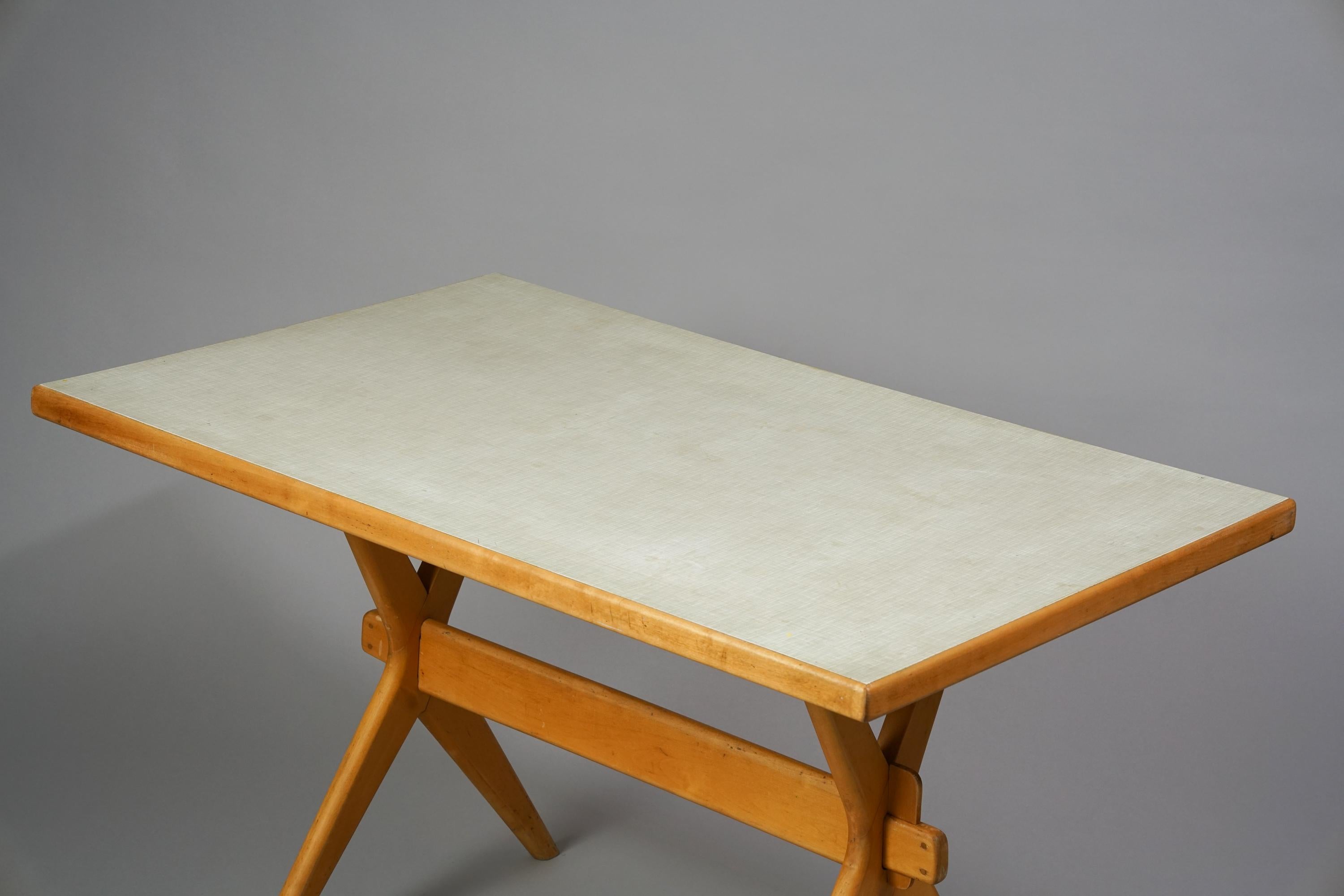 Ilmari Tapiovaara X Leg Dining Room Table from the 1950s. Birch frame with vinyl table top. Good vintage condition, wear and patina consistent with age and use.