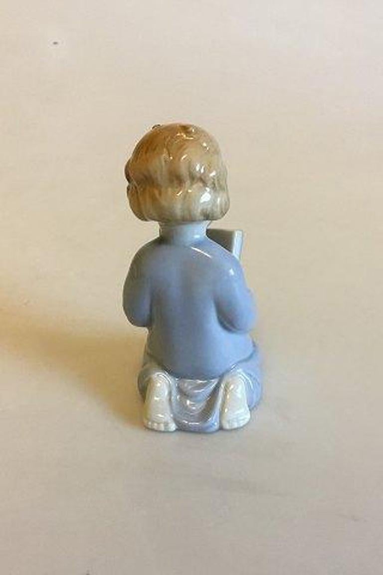 Ilmenau figurine of girl with book. 

Measures 9 cm / 3 35/64 in.
 