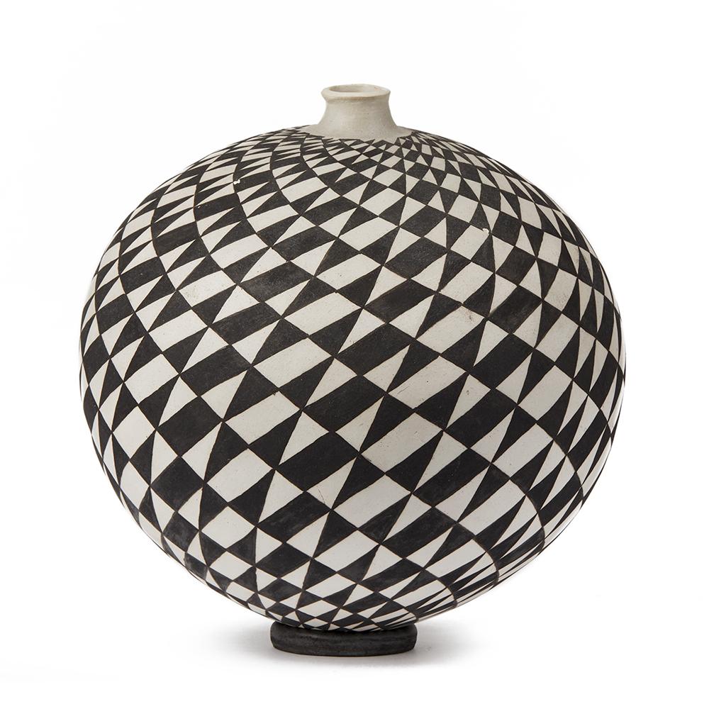A stunning Czech, Ilona Sulikova Raku fired black and white ceramic studio pottery vase decorated with a swirling traingular pattern with a small matching circular stand. The rounded vase has a narrow raised neck and is fired and then completed by